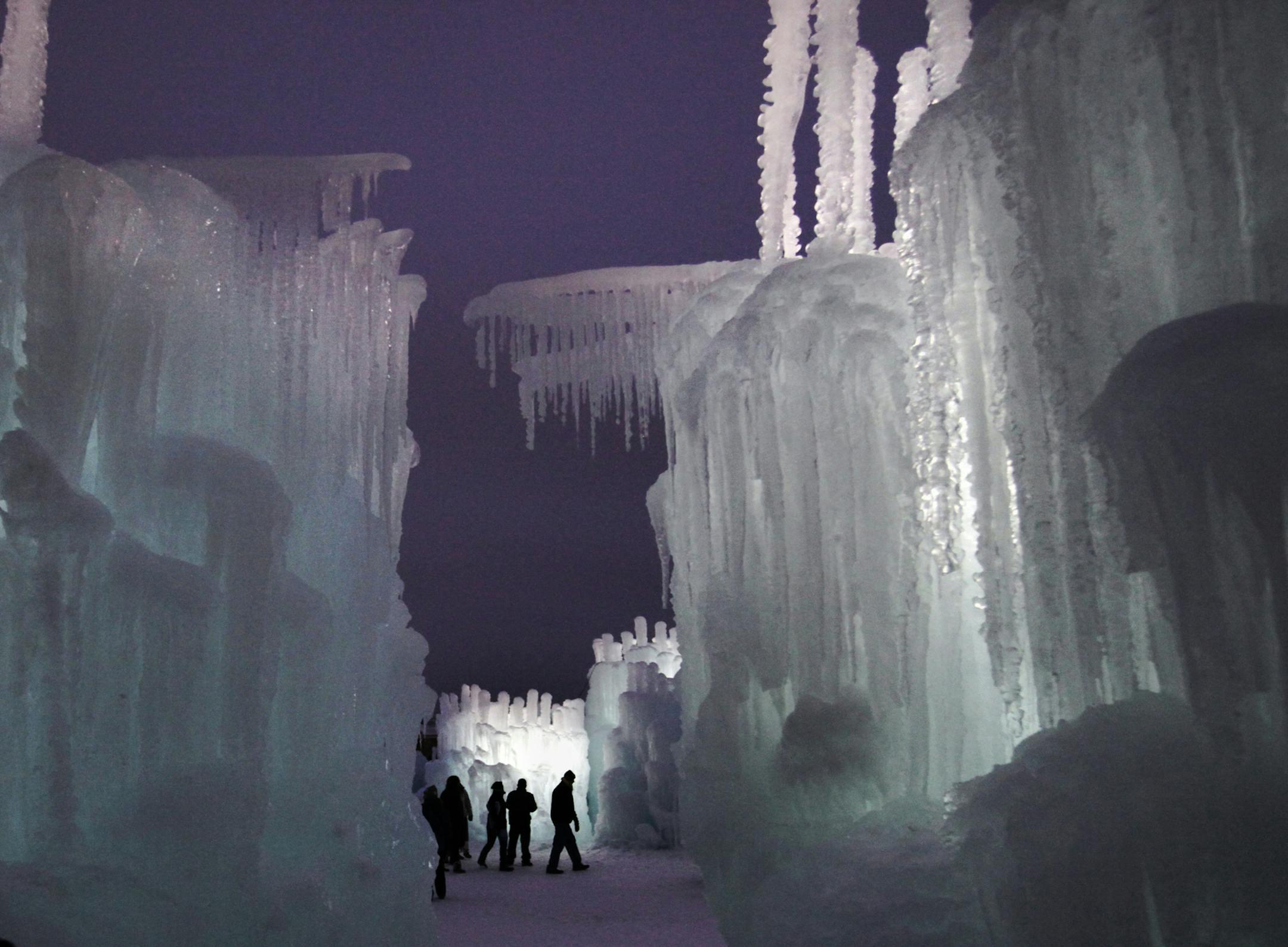 Visitors to the Ice Castles are seen touring the icy attraction Tuesday, Jan. 1, 2013, at the MOA parking lot in Bloomington, MN. (DAVID JOLES/STARTRIBUNE) djoles@startribune.com Ice Castles, some towering 40 feet tall, made of ice fused together from 4 million gallons of water and covering two acres, is now open in the north parking lot of the MOA. ORG XMIT: MIN1301011921583480