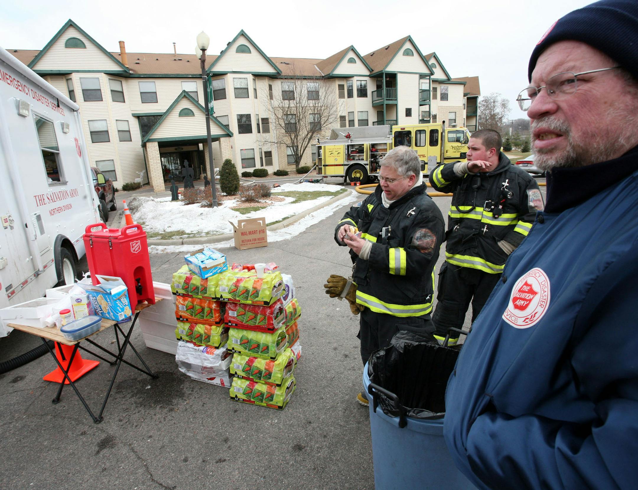Salvation Army emergency disaster services volunteer Jim Daly, right, served food and coffee to firefighters at an apartment fire in St. Anthony in February 2009.
