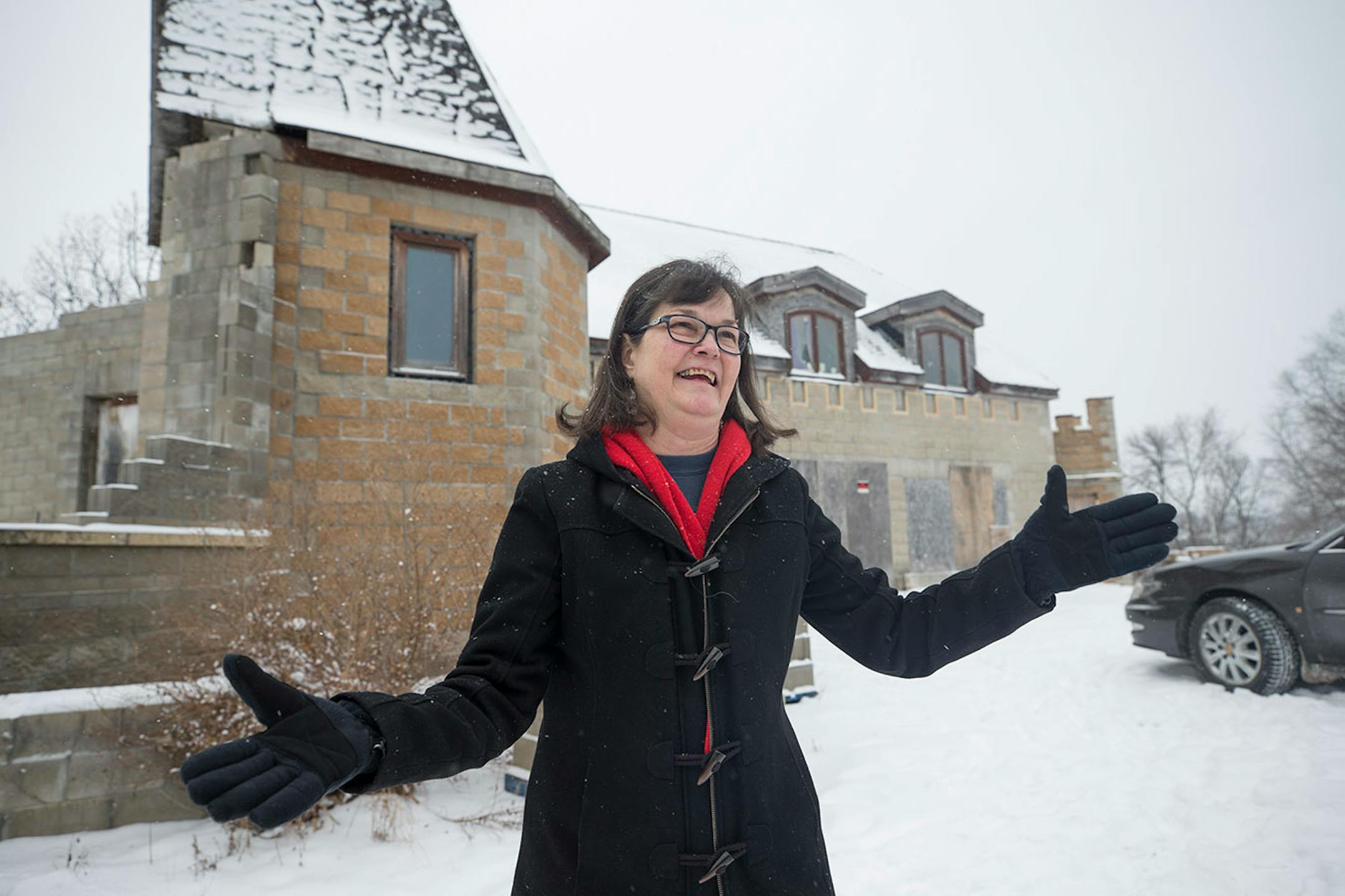 Beth Arntson stood outside of a dream castle that she and her husband, Gary Arntson, started to build themselves 20 years ago. Because of illness, they are selling their castle.