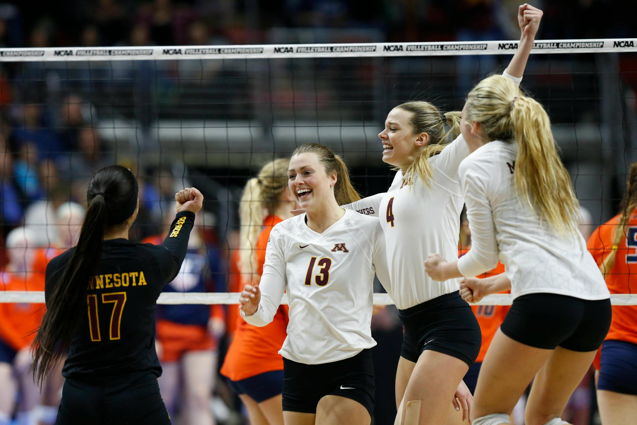 Minnesota players celebrate during an NCAA college volleyball game, Friday, Dec. 11, 2015 in Des Moines