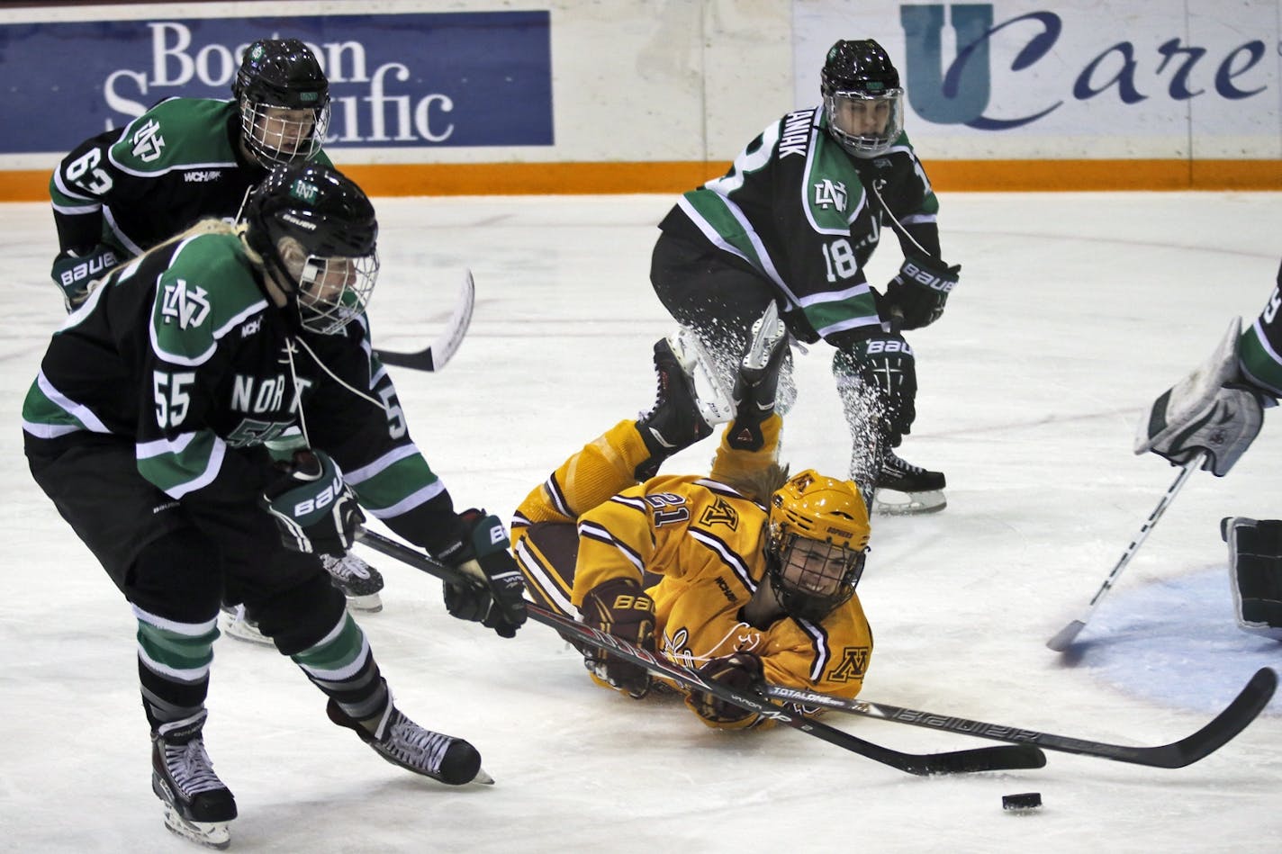 The Gophers women's hockey team's 62-game winning streak ended Sunday in a 3-2 loss to North Dakota. Minnesota's Meghan Lorence hit the ice in pursuit of the puck in the first period.