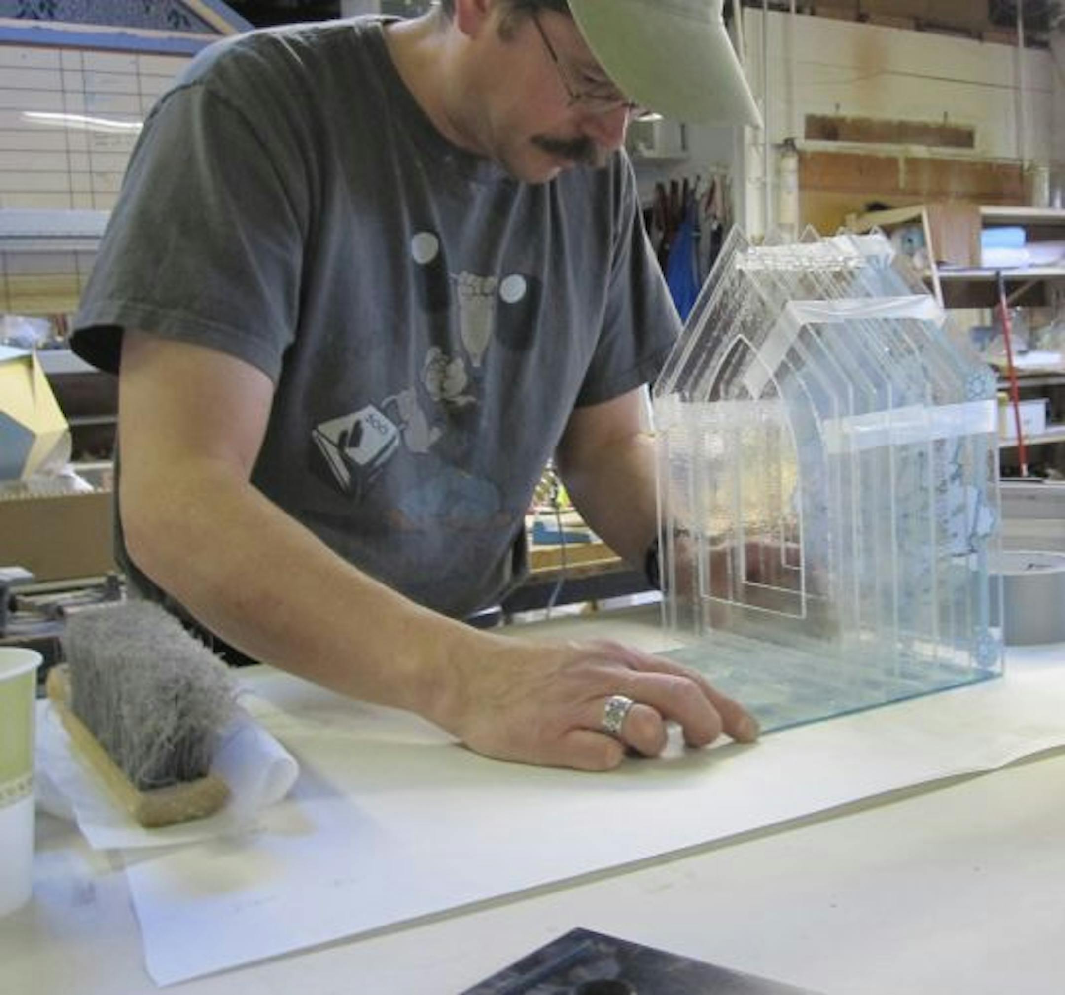 Mormon sculptor Andrew Kosorok, seen here creating a "Merciful" sculpture, is creating 99 glass sculptures to represent Islam's 99 names for God