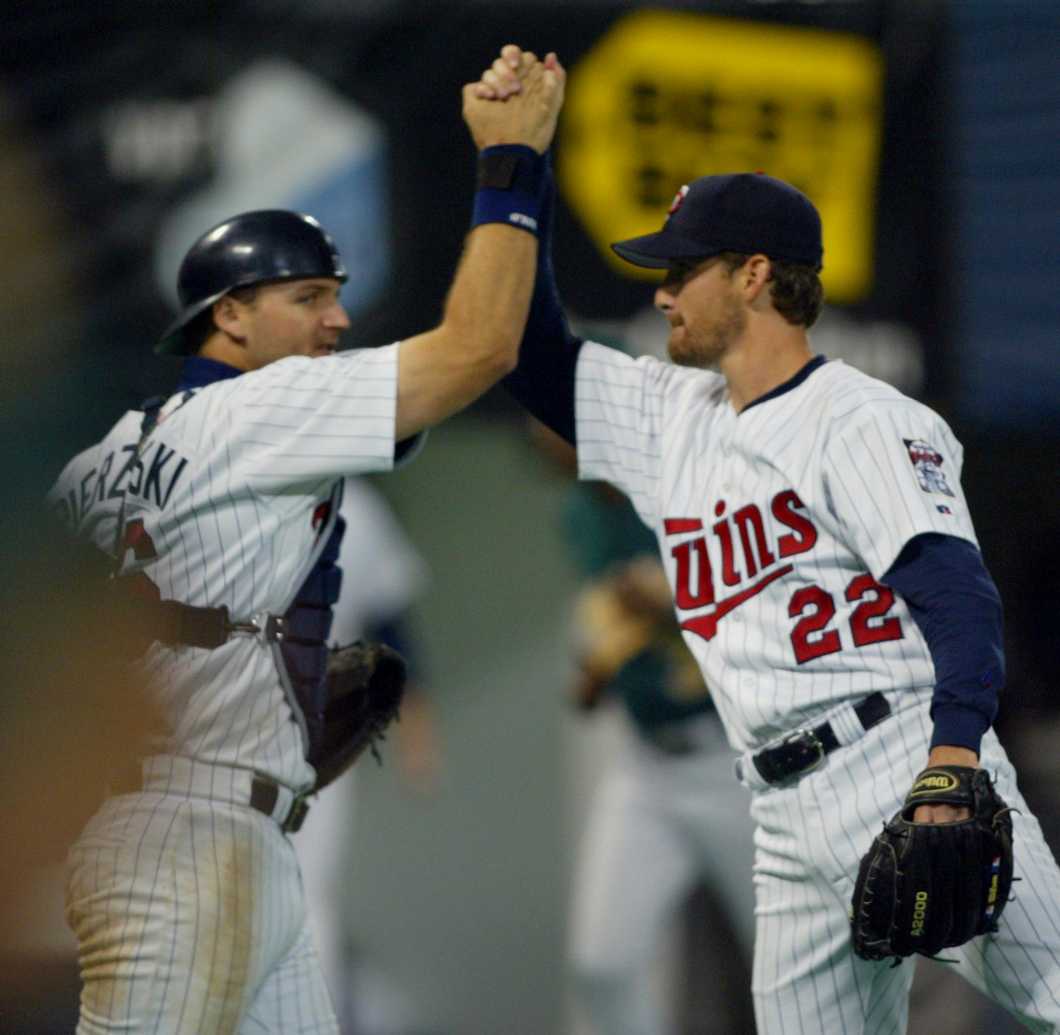 MINNEAPOLIS - 9/6/02 - The Twins shut out the Oakland Athletics 6 - 0 to end the Athletics' 20 game winning streak Friday night at the Metrodome. IN THIS PHOTO: Pitcher Brad Radke, right, and catcher A.J. Pierzynski celebrate the Twins' streak-ending shutout of the Oakland A's Friday night. ORG XMIT: MIN2013032619230676