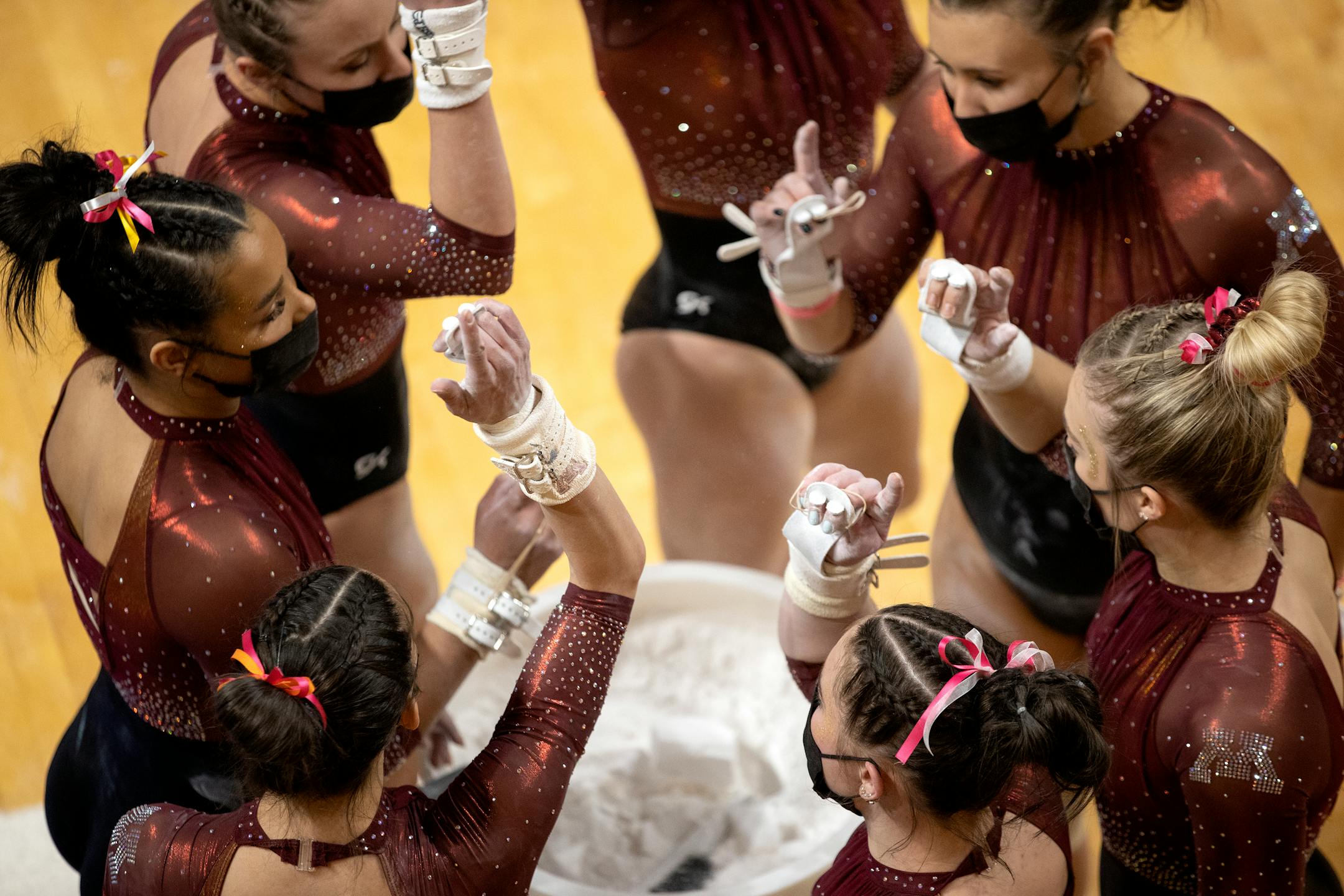 Minnesota gymnasts huddled up before competing against Michigan.