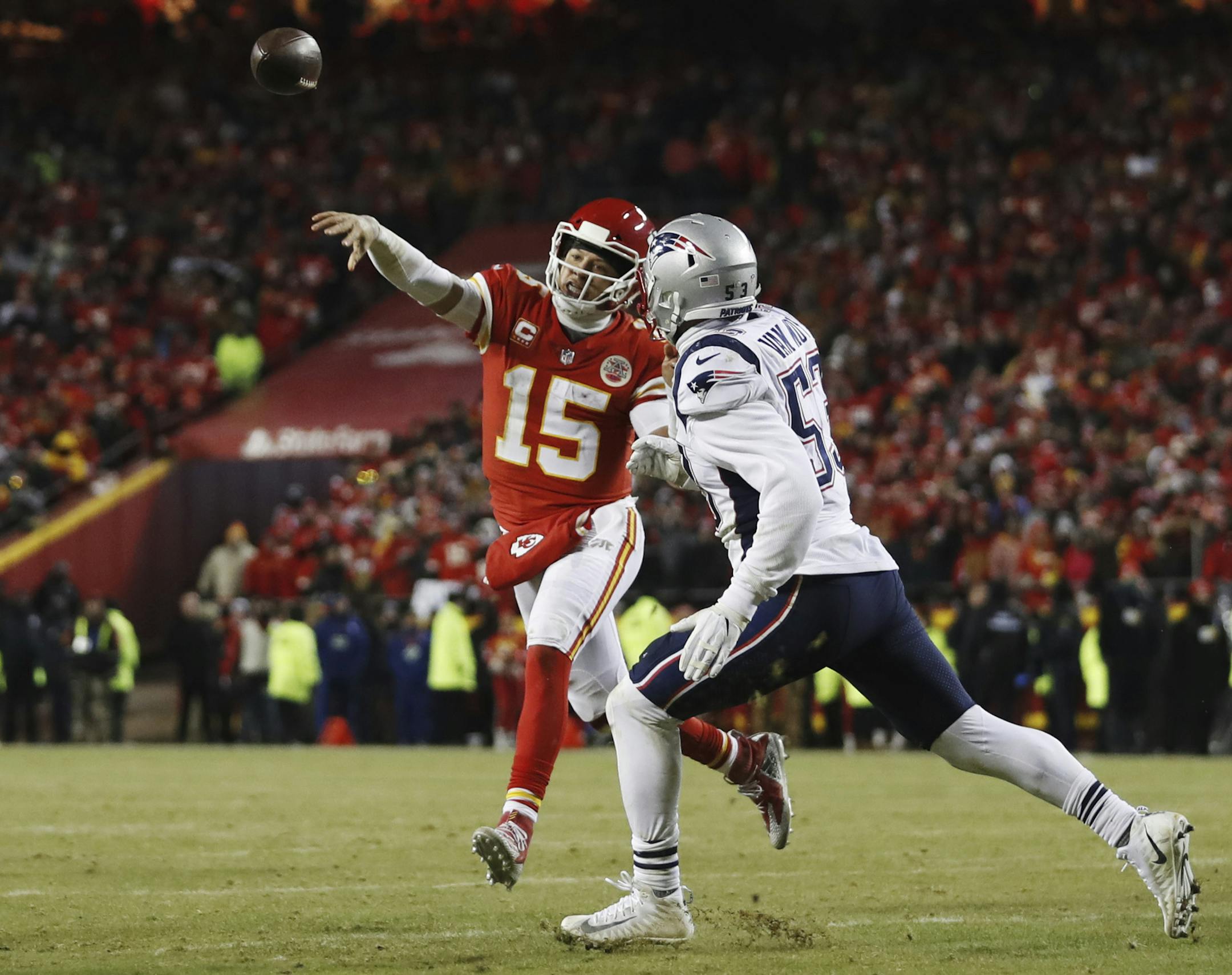 Kansas City Chiefs quarterback Patrick Mahomes (15) throws a touchdown pass to running back Damien Williams against New England Patriots middle linebacker Kyle Van Noy (53) during the second half of the AFC Championship NFL football game, Sunday, Jan. 20, 2019, in Kansas City, Mo. (AP Photo/Jeff Roberson)