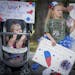 Lehla Dolsen, 4, right, and her cousin Rylie Vokoun, left, 10 months, watched as a bus carrying Dolsen's dad Shawn Dolsen and more than 200 other sold