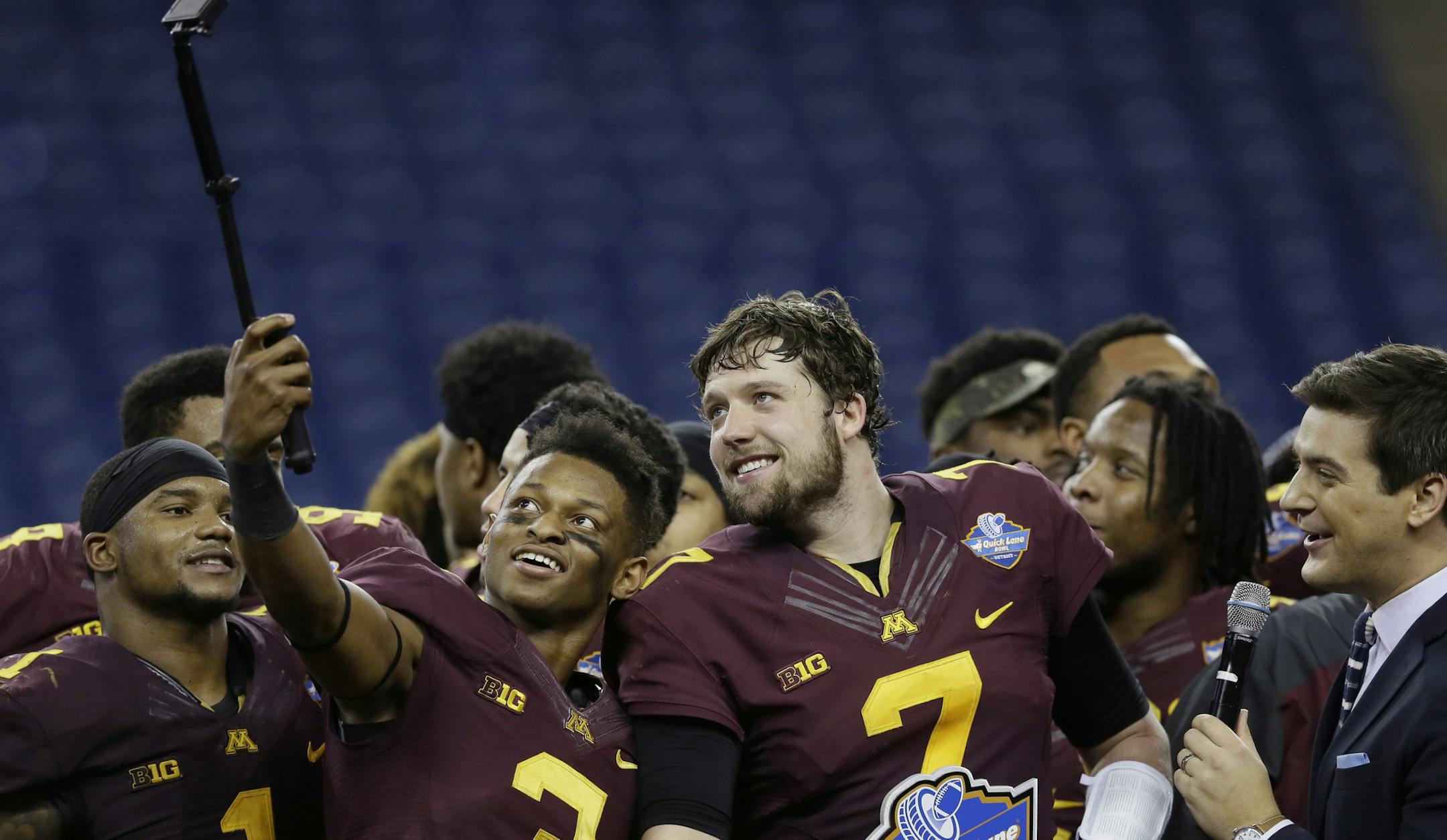 Minnesota defensive back KiAnte Hardin (3) takes a photo with quarterback Mitch Leidner (7) after their Quick Lane Bowl NCAA college football game against Central Michigan, Monday, Dec. 28, 2015, in Detroit. Minnesota defeated Central Michigan 21-14. (AP Photo/Carlos Osorio)