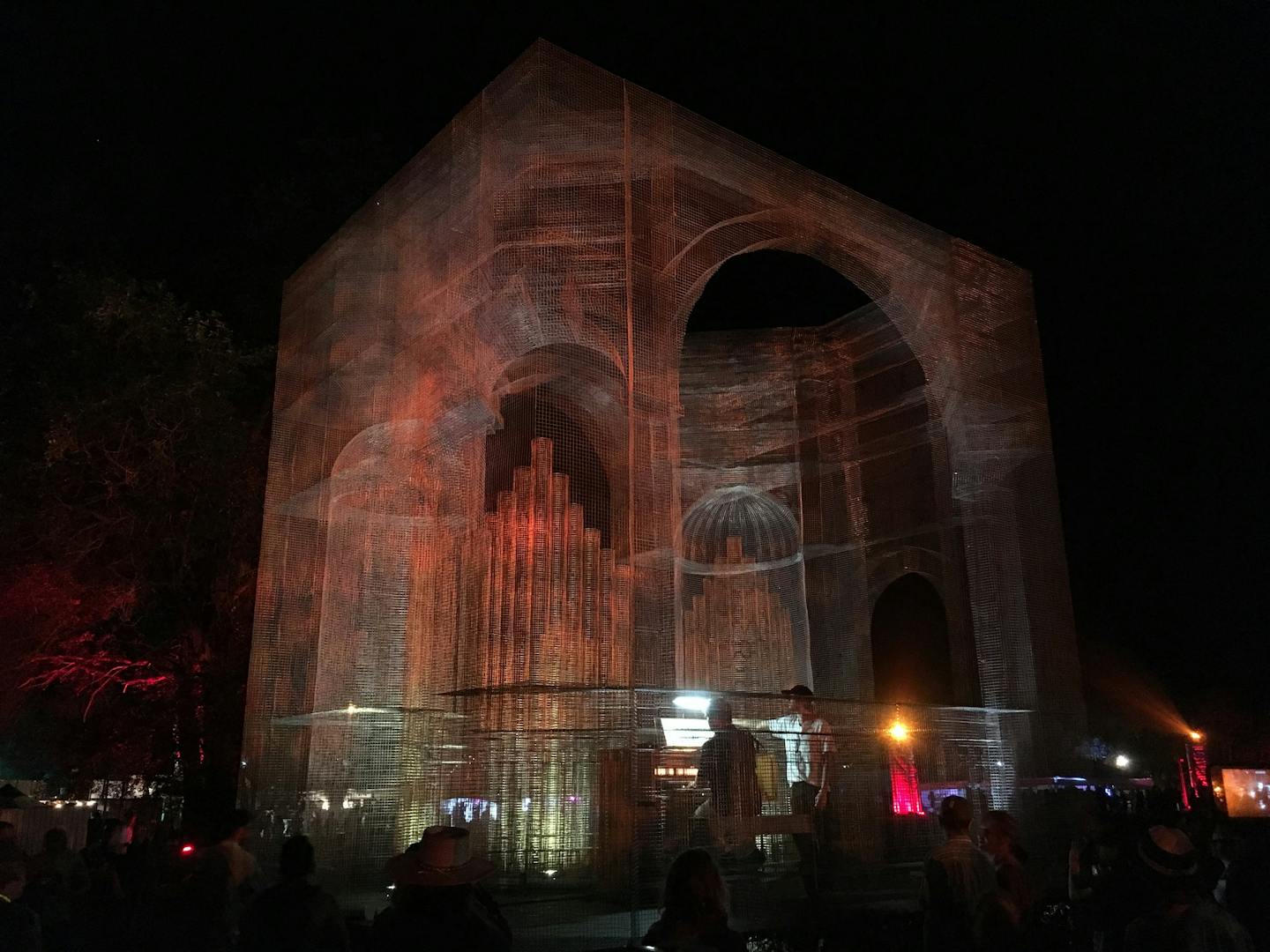 At night, a ghostly baroque cathedral was a focal point at the Eaux Claires festival grounds. Constructed from metal mesh by sculptor Edoardo Tresoldi, it housed an organ, played here by Griffin McMahon.