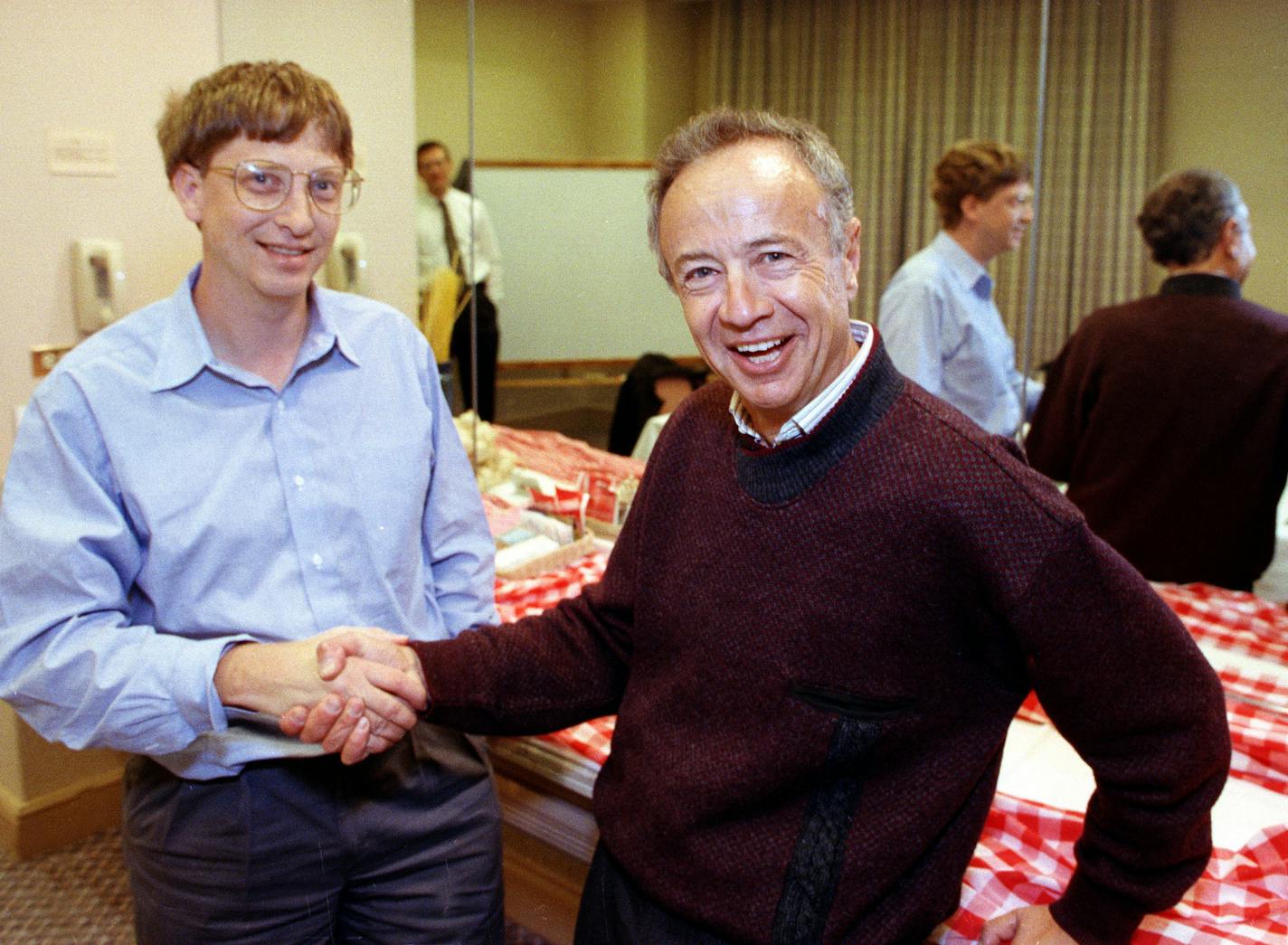 FILE- In this Nov. 9, 1992, file photo, Intel Corp. President Andy Grove, right, shakes hands with Microsoft Chairman Bill Gates at a meeting in Burlingame, Calif. Grove, the former Intel Corp. chief executive whose youth under Nazi occupation and escape from the Iron Curtain inspired an "only the paranoid survive" management philosophy that saved the chip maker from financial ruin in the 1980s, has died. Intel said Grove died on Monday, March 21, 2016. He was 79. (AP Photo/Paul Sakuma, File)