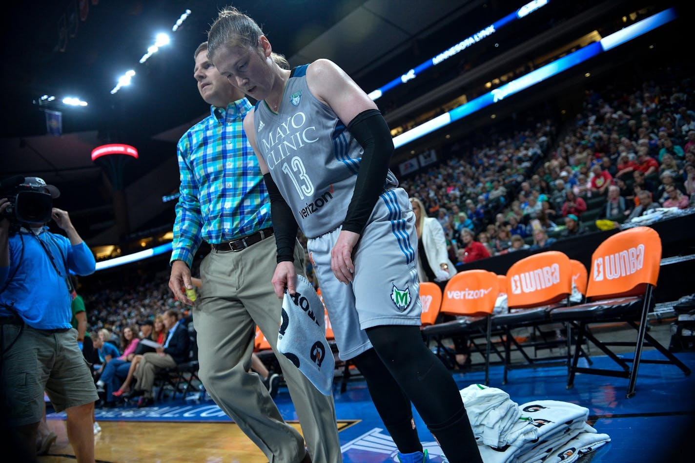 Minnesota Lynx guard Lindsay Whalen (13) was escorted to the locker room after injuring her left hand in the third quarter against the Atlanta Dream on Thursday.