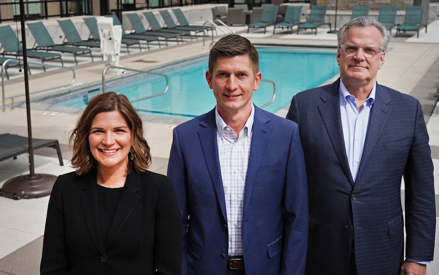 CEO Anne Behrendt said developer-contractor Doran Companies was justified in taking a $1 million forgiveable "paycheck protection" loan from the federal government. Behrendt, left, posed with CFO Ryan Johnson and founder Kelly Doran at a Doran apartment complex in Minneapolis in 2019. Star Tribune file photo