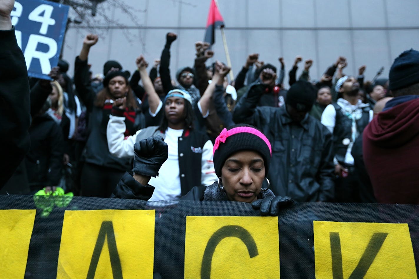 Monique Cullars-Doty raised her fist during a prayer during a rally.