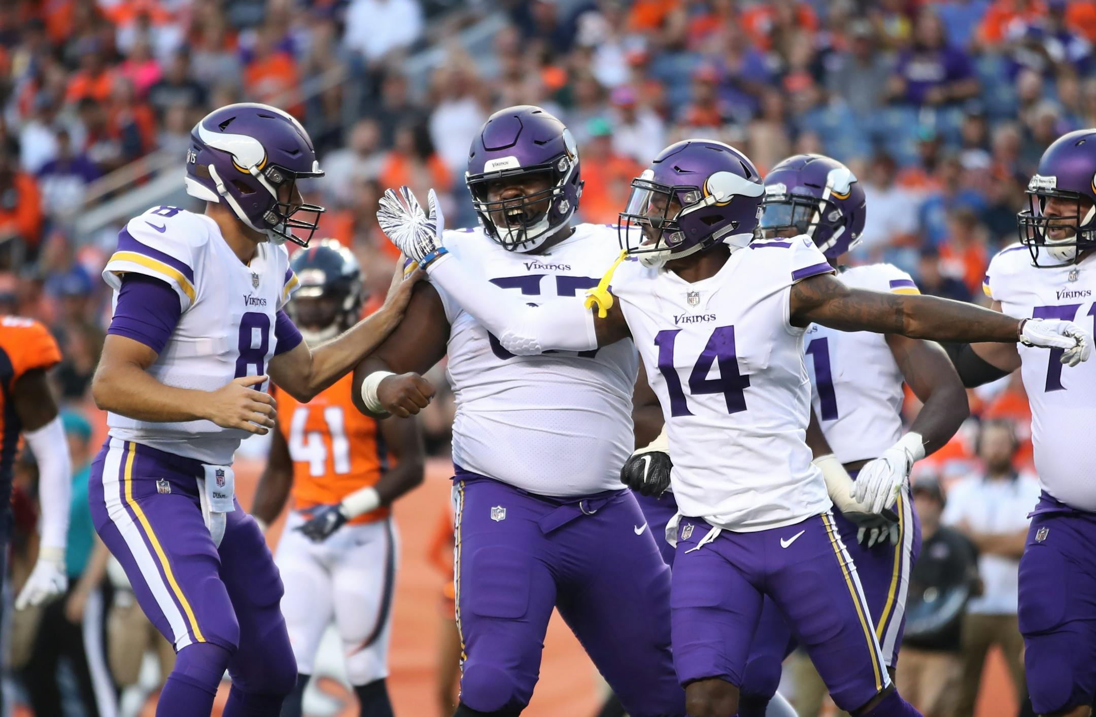 Minnesota Vikings quarterback Kirk Cousins (8) celebrated with receiver Stefon Diggs (14) after a touchdown Saturday August 11, 2018 at Mile High Stadium in Denver, CO.