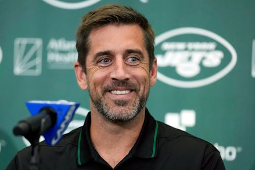 FILE - New York Jets' quarterback Aaron Rodgers smiles during an NFL football news conference at the Jets' training facility in Florham Park, N.J., Wednesday, April 26, 2023. Months after Colorado's voters decided to join Oregon in decriminalizing psychedelic mushrooms, Denver will host a conference this week put on by a psychedelic advocacy group bringing together an unlikely cohort of speakers — including Rodgers, former Texas Gov. Rick Perry, and rapper Jaden Smith, the son of actor Will Smith. (AP Photo/Seth Wenig, File)