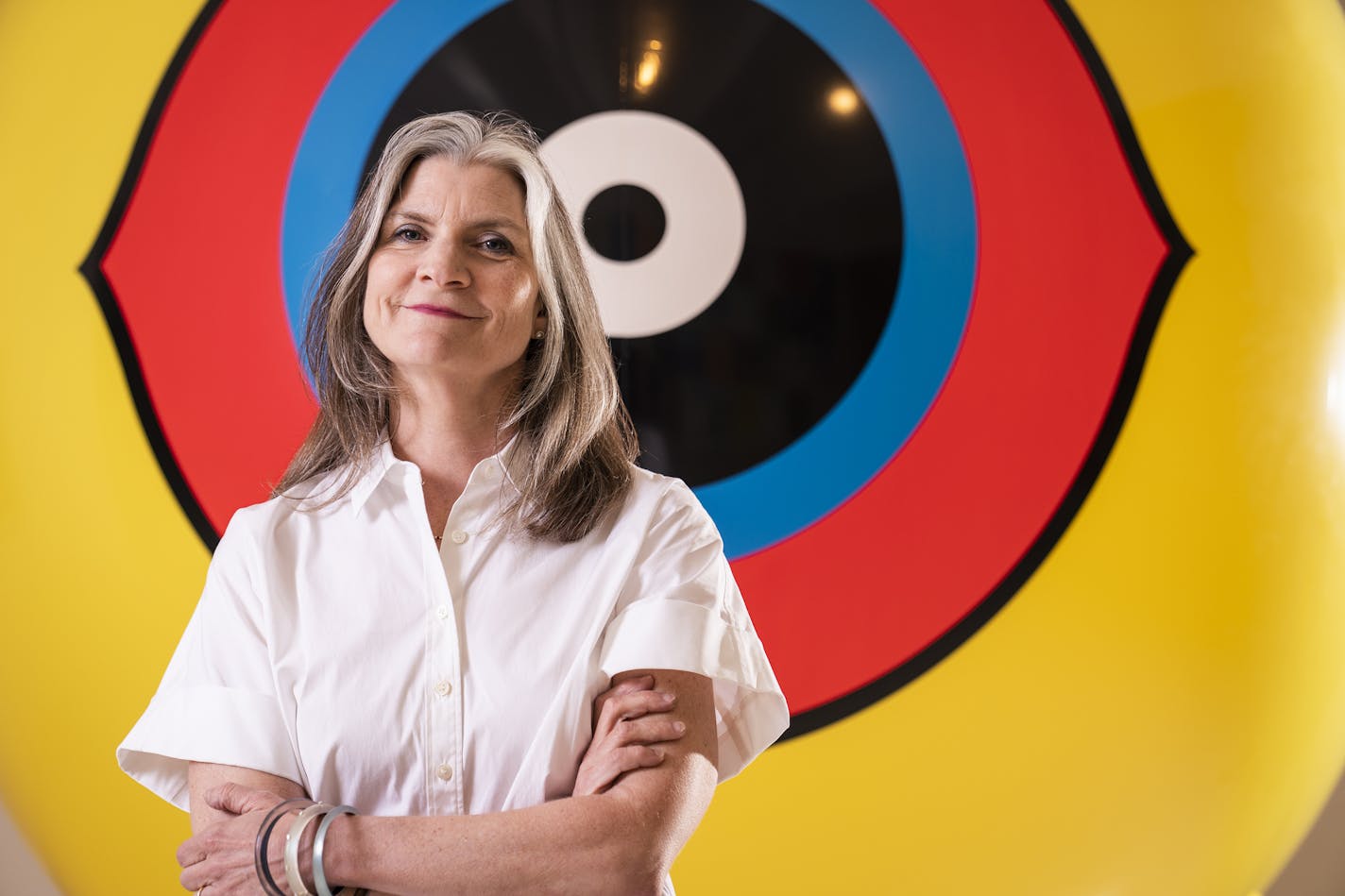 All eyes on Mary Ceruti: The Walker director posed with a giant "scare eye" balloon that the art collective Postcommodity used in making "Repellent Fence," an installation along the U.S.-Mexico border.