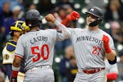 Ryan Jeffers, right, was greeted by teammate Willi Castro after hitting a three-run home run in the seventh inning Wednesday in Milwaukee.