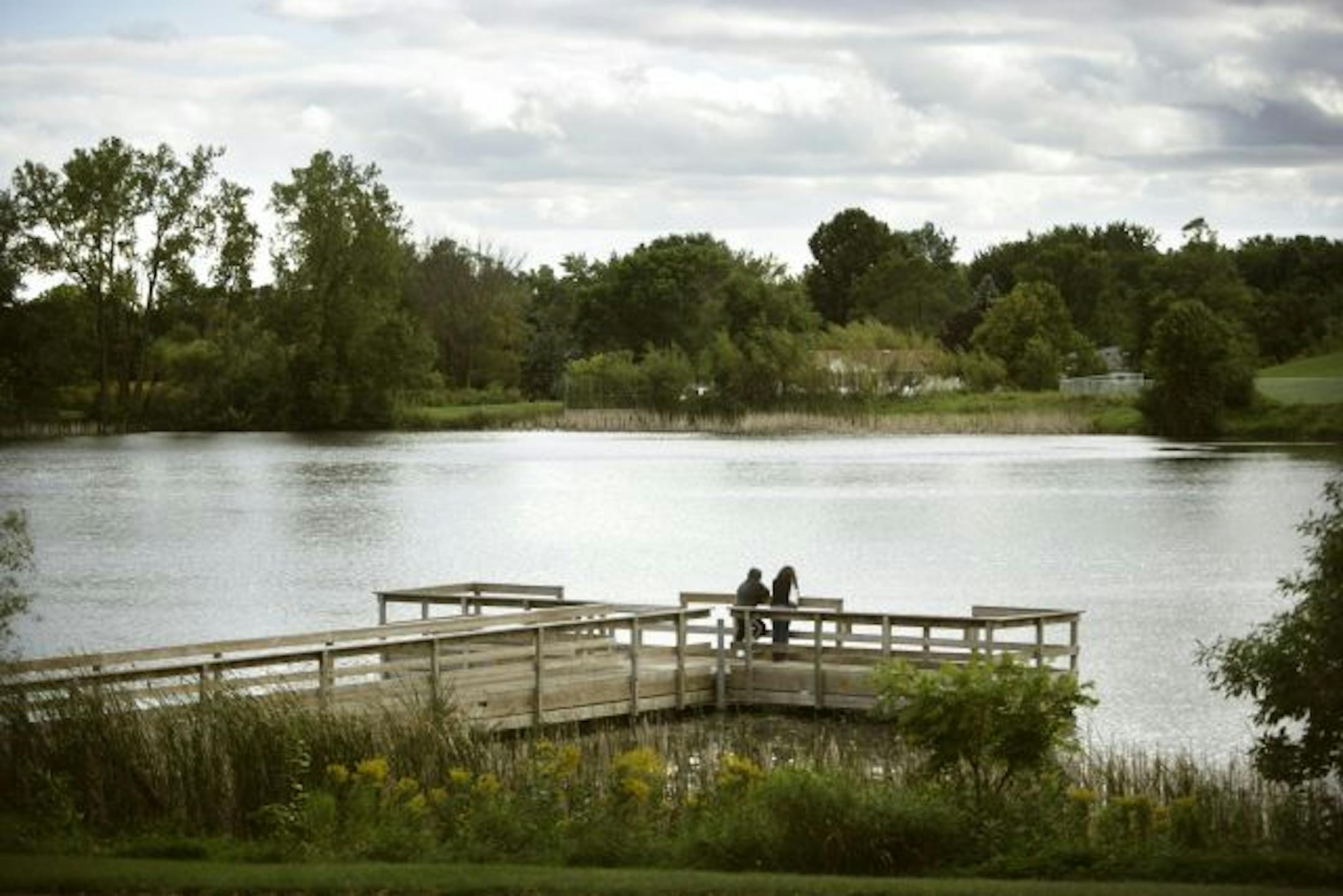 People look at Thompson Lake in West St. Paul from the fishing pier on the East end of the Lake.