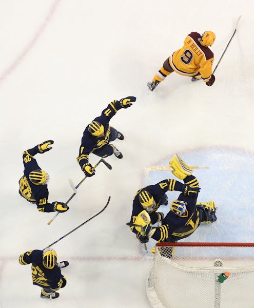 The Michigan Wolverines celebrated their 5-3 Big 10 championship victory over Minnesota Golden Gophers Saturday night.
