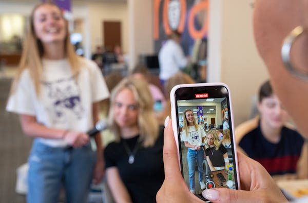 University of St. Thomas student Sophia Huber records a video as Olivia Russell interviews Kaylee Olson, a fellow student, for a TikTok on why she cho