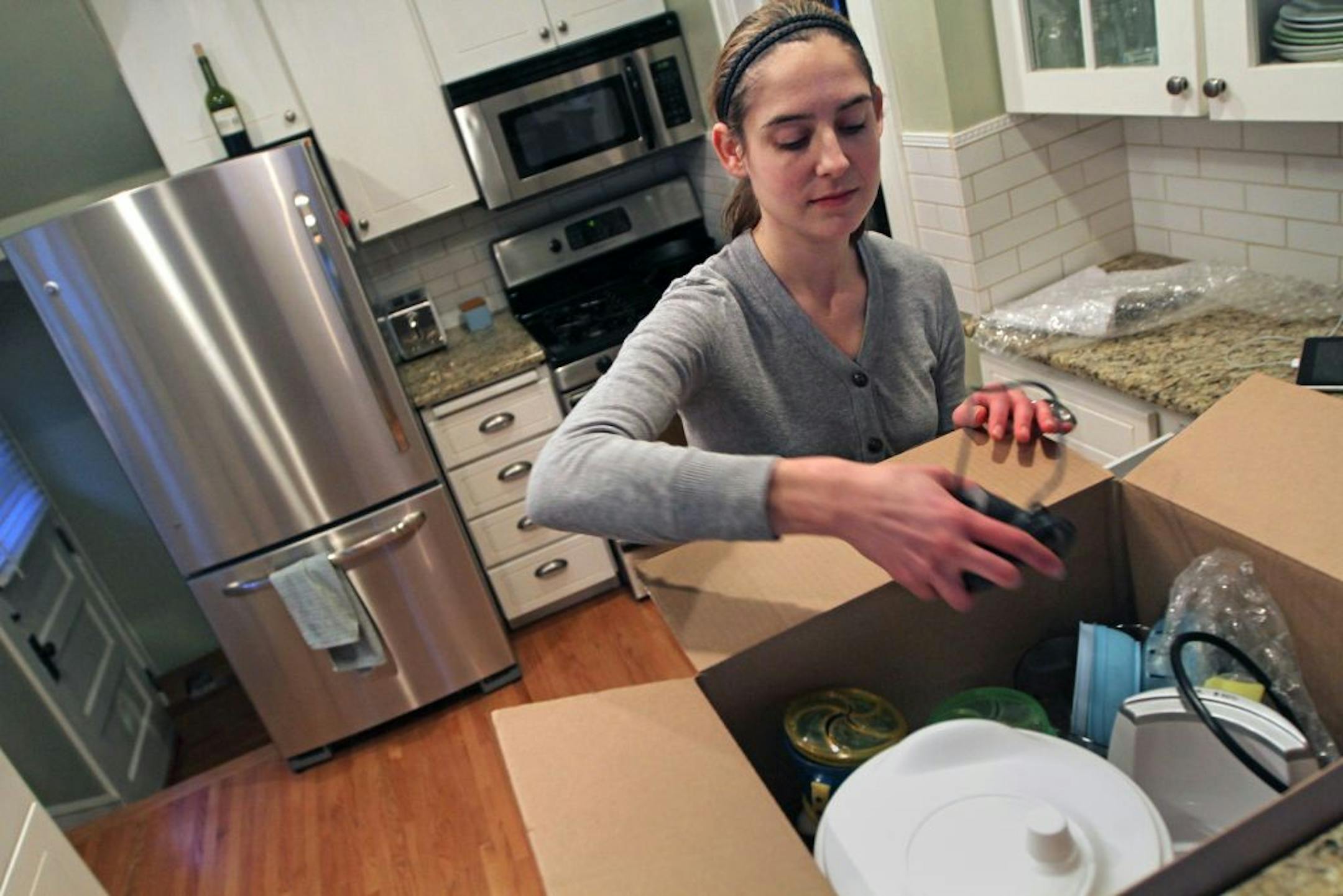 Stephanie Coogan packed items in preparation to move from her south Minneapolis house, which drew a full-price offer from the first person to look at it.