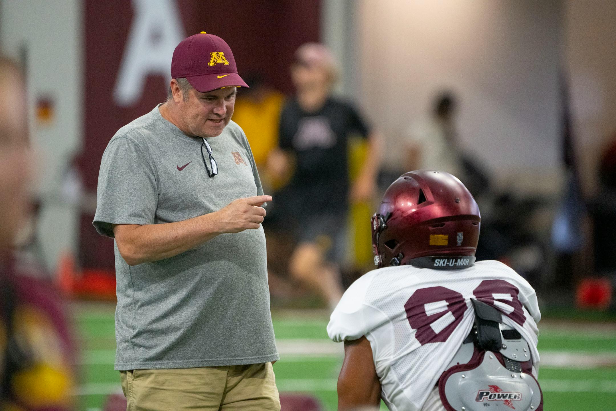 Gophers football offensive coordinator Kirk Ciarrocca speaks with players during the football team's open practice Saturday.