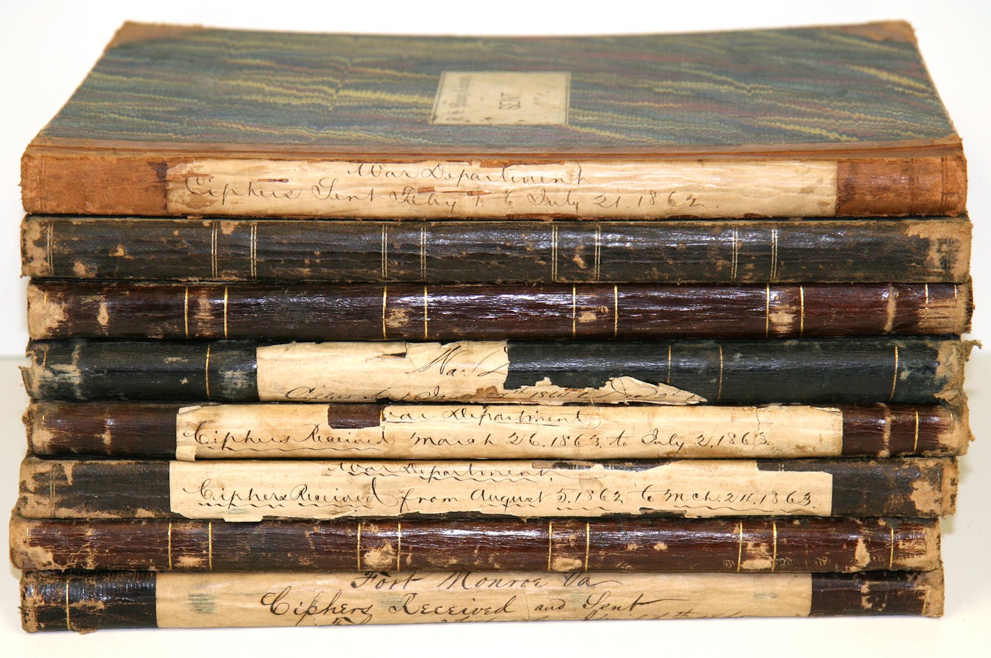 A stack of ledger books containing coded telegraphs sent and received by the War Department during the Civil War.