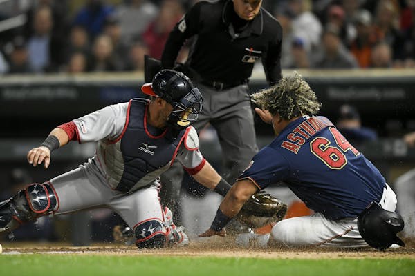 Minnesota Twins catcher Willians Astudillo (64) was tagged out at home by catcher Yan Gomes (10) on a fielder's choice hit by center fielder Ryan LaMa