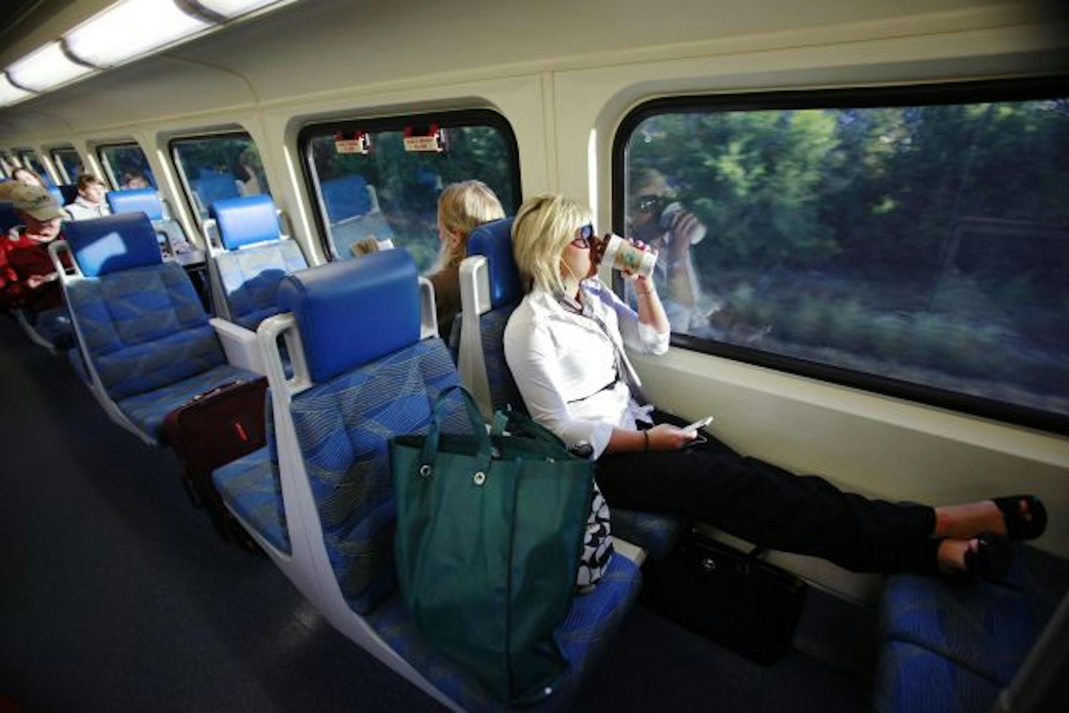 Alissa Ostroot of Big Lake enjoys a coffee while on her daily commute to downtown Minneapolis "It's been good," Ostroot says of the train commute. "I have a coffee, listen to my iPod and fall asleep."