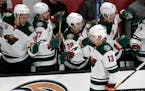 Minnesota Wild center Nick Bonino (13) is congratulated by teammates after scoring against the Anaheim Ducks during the second period of an NHL hockey