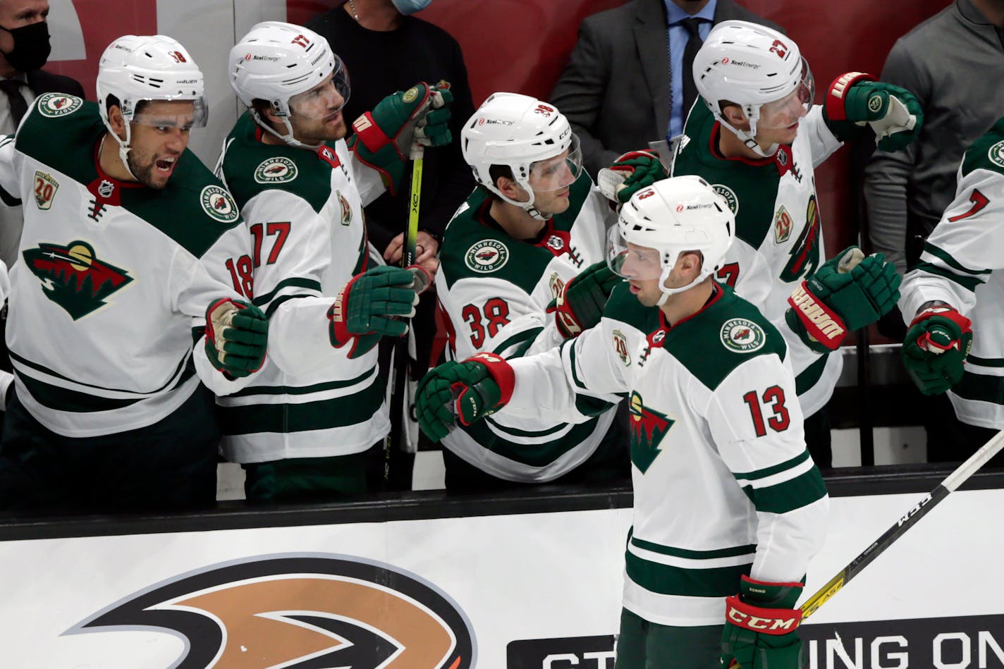 Minnesota Wild center Nick Bonino (13) is congratulated by teammates after scoring against the Anaheim Ducks during the second period of an NHL hockey game in Anaheim, Calif., Wednesday, Jan. 20, 2021. (AP Photo/Alex Gallardo)