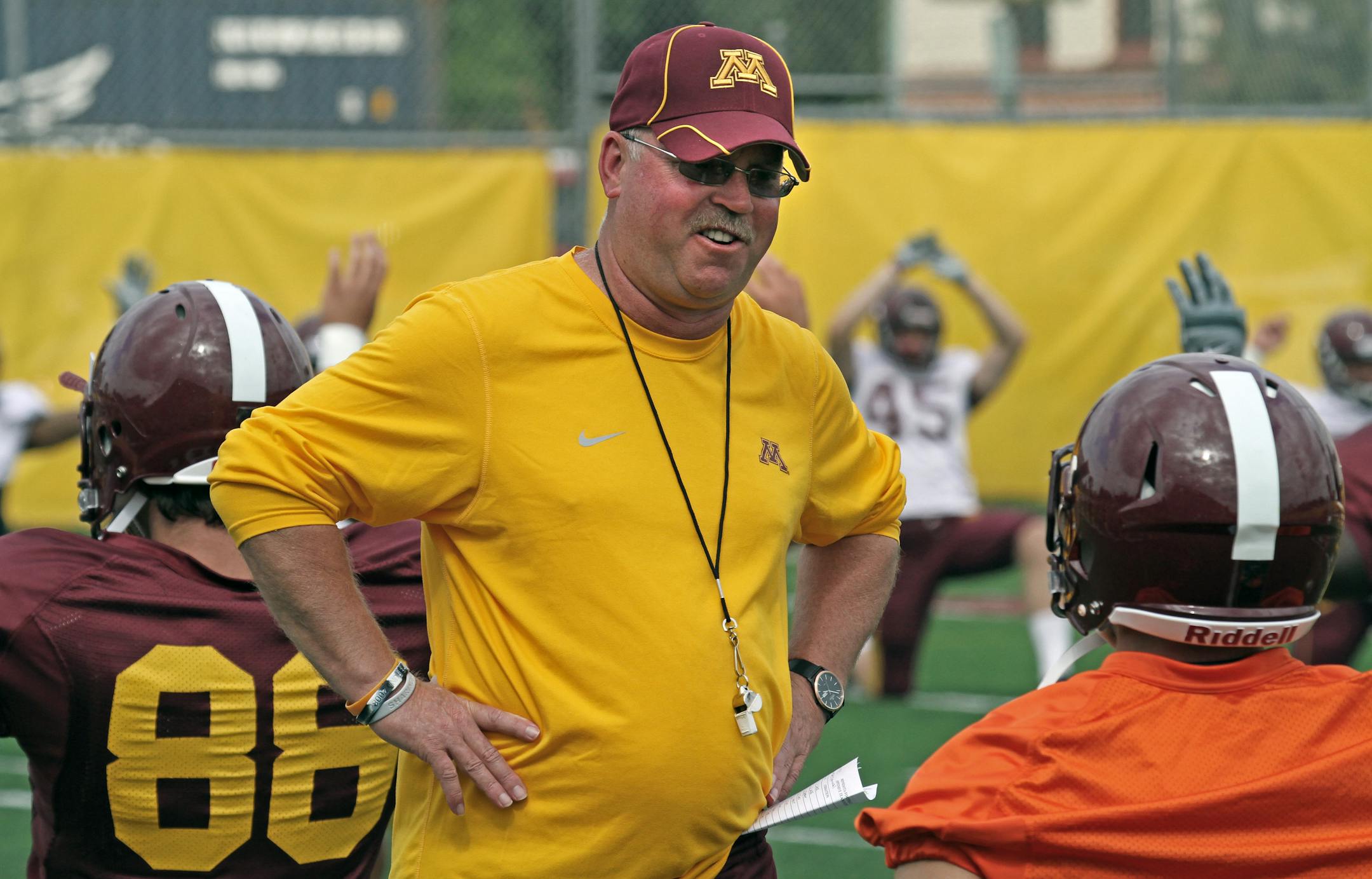 Jerry Kill, talking with one of his players during preseason practice, knows he can't control everything a player does. ''I spend more time teaching them how to act ... than I do coaching football,'' he said.