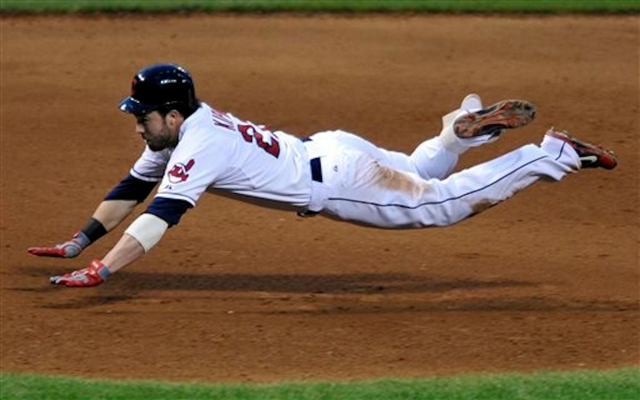 Cleveland's Jason Kipnis slid into third base with a triple in the fourth inning against the Twins on Saturday.