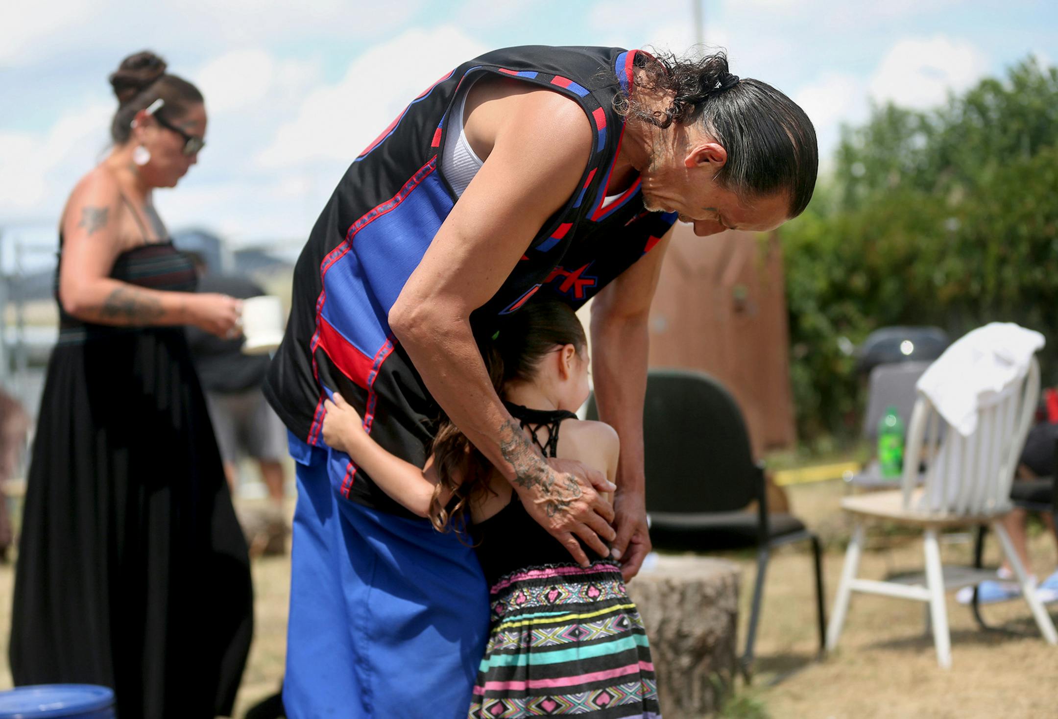James Cross, the founder of the street outreach group Natives Against Heroin, spent nearly half of his life in prison for drug-related crimes but is working hard now to help people in his Native American community, particularly the poor and those with substance abuse problems. Here, Cross, hugs his grand daughter, 4, who he and his wife had been raising during a sweat lodge ceremony he and NAH members held near the Minneapolis Indian Center Sunday, July 16, 2017, in south Minneapolis, MN. Some o