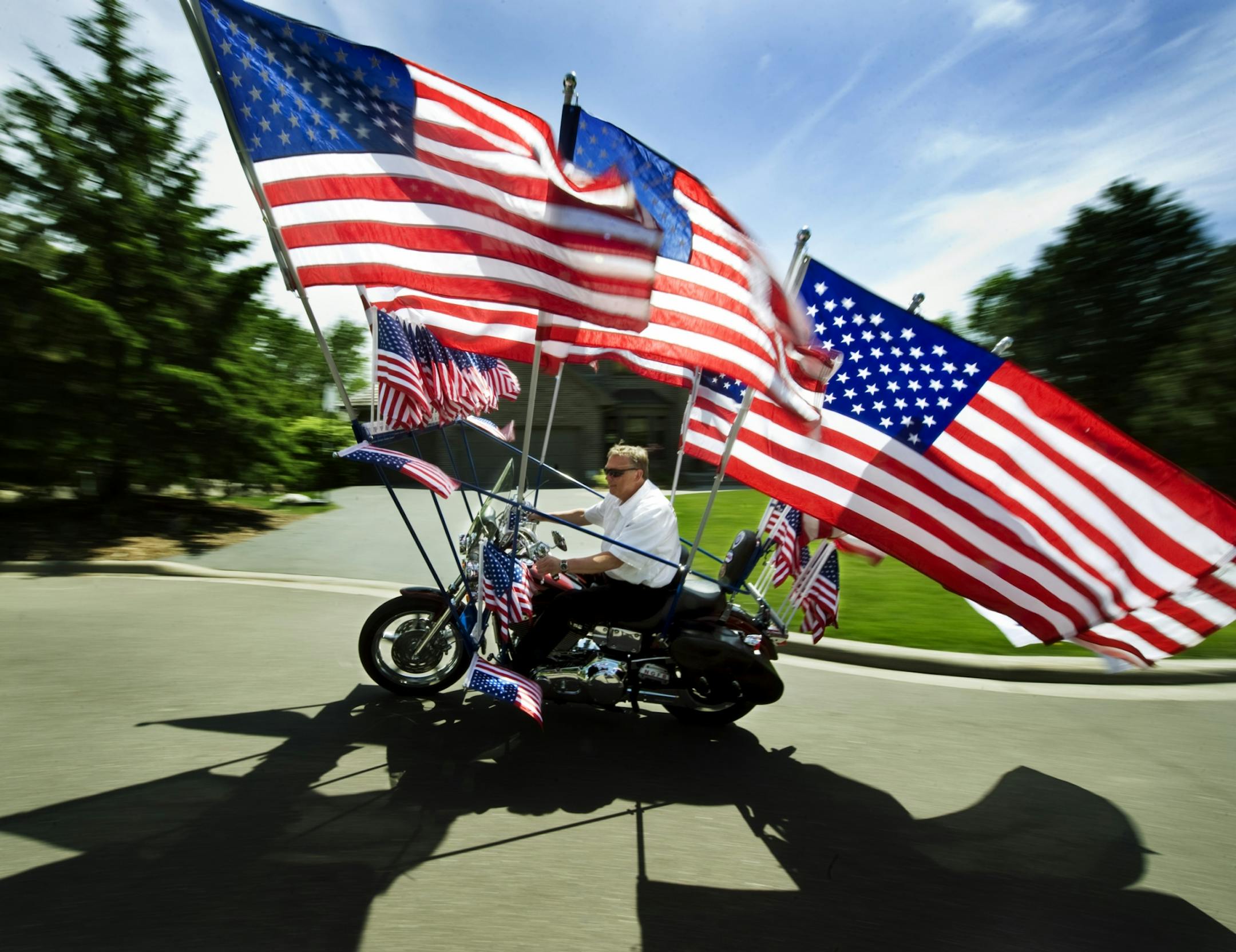 Chris Hawver of the Twin Cities-based New Glory Flag Bike Team showed off his specially modified Harley-Davidson and its 50 flags. Hawver and six other Harley riders honor U.S. troops by appearing free of charge at various public events.