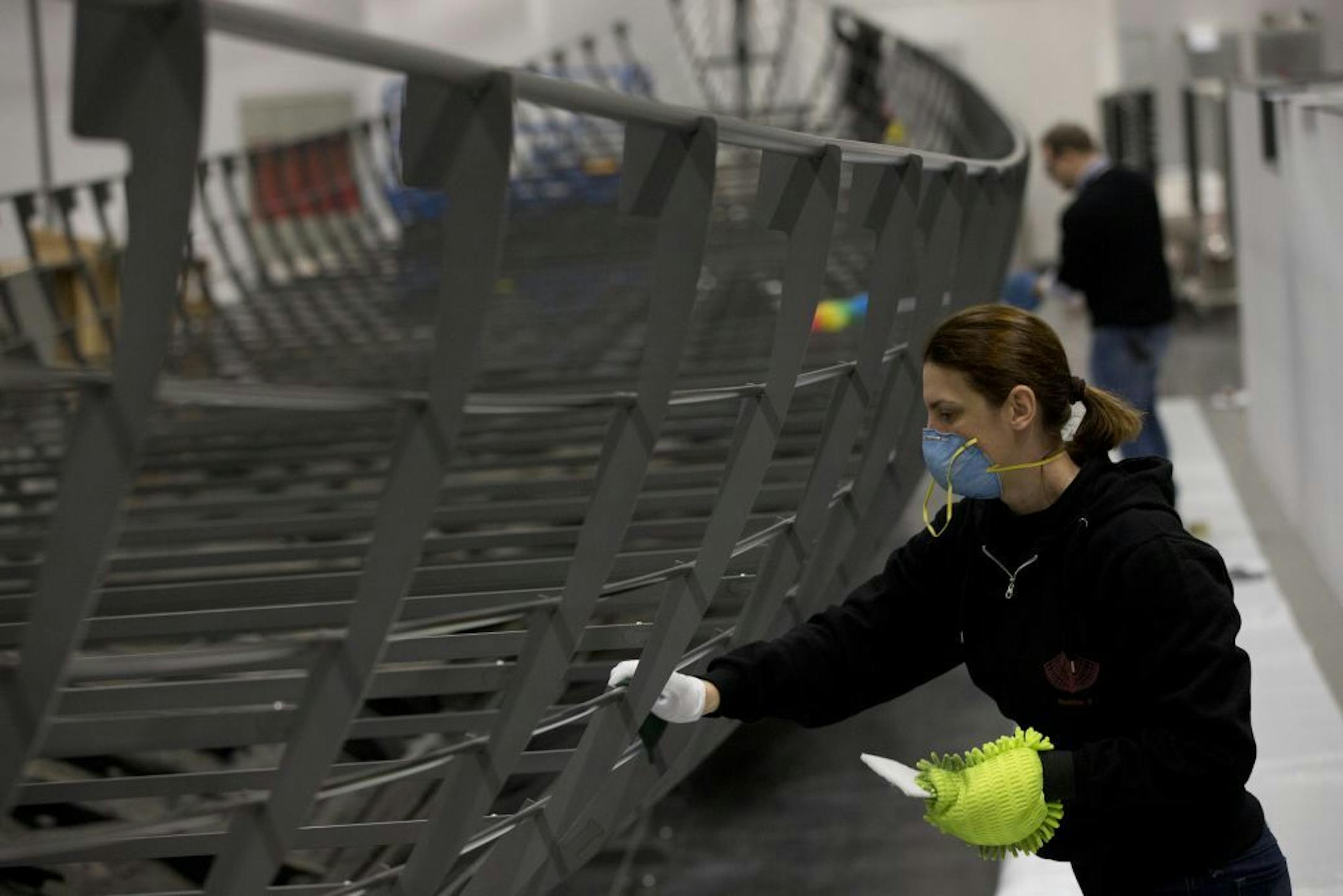 A conservator helps with the final assembly of The Viking ship known as Roskilde 6, of which about 20 per cent of the timber remains and which is dated to around 1025 AD, at the British Museum in London, Friday, Jan. 17, 2014.
