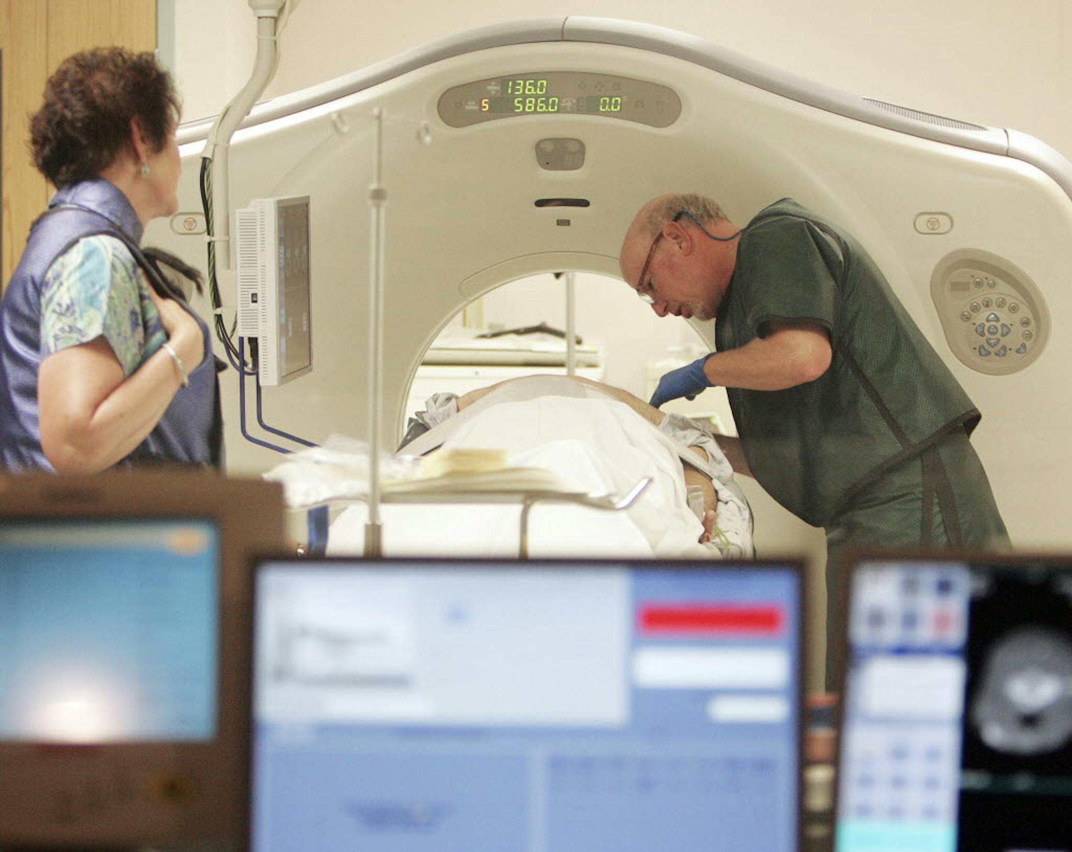 Dr. Steven Birnbaum works with a patient in a CT scanner at Southern New Hampshire Medical Center in Nashua, N.H.