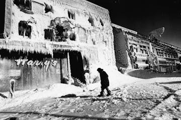 Mrs. Fred McNee, of Wayzata, surveyed the damage Sunday at Harry&#xd5;s Cafe at 11th and Nicolette Ave. Her father, Harry Doust, founded the restauran