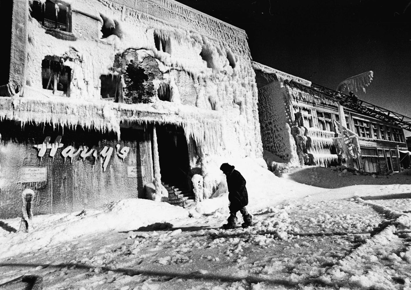 Mrs. Fred McNee, of Wayzata, surveyed the damage Sunday at Harry&#xd5;s Cafe at 11th and Nicolette Ave. Her father, Harry Doust, founded the restaurant. Harry&#xd5;s Cafe, a downtown Minneapolis landmark for more than 50 years, was destroyed by fire Sunday morning, Jan. 8, 1978. (Richard Olsenius)