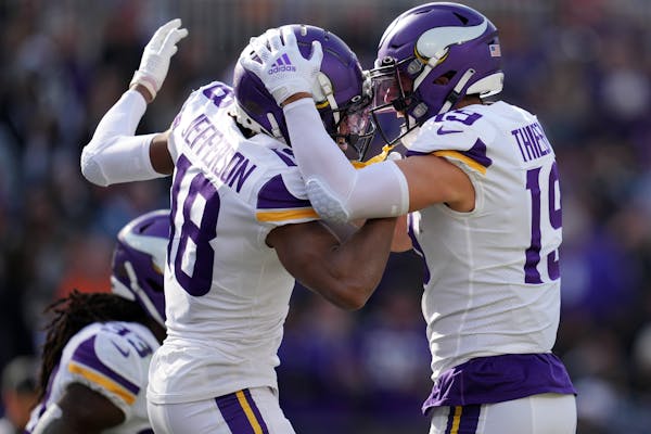 Vikings wide receiver Justin Jefferson (18) celebrates with fellow wide receiver Adam Thielen (19) after running in a 50-yard touchdown pass from quar