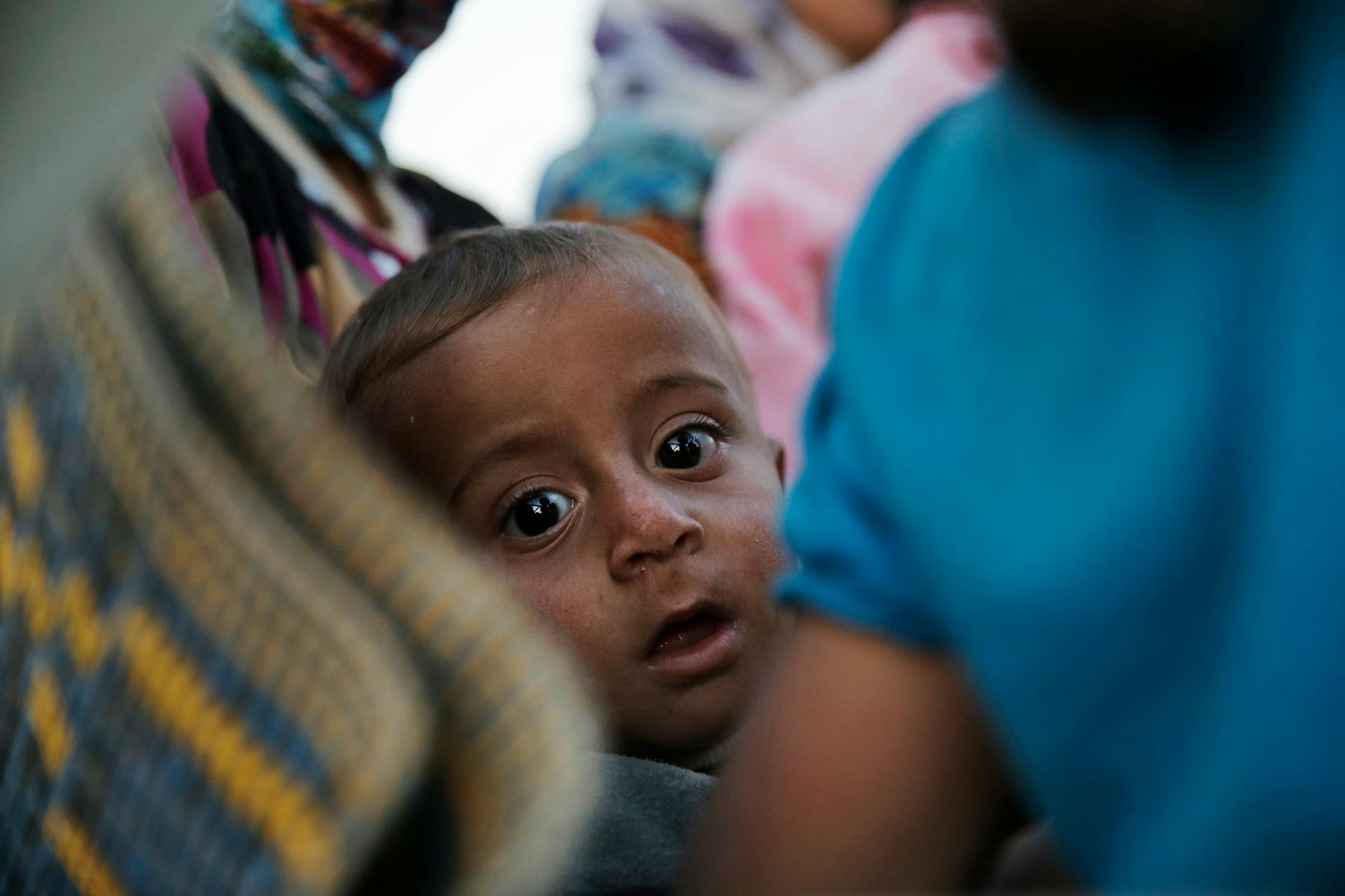 A baby looked on as Syrian Kurdish refugees board a truck near Suruc, Turkey, on Sunday, after their arrival from Kobani, as fighting intensified between Syrian Kurds and the militants of Islamic State group.