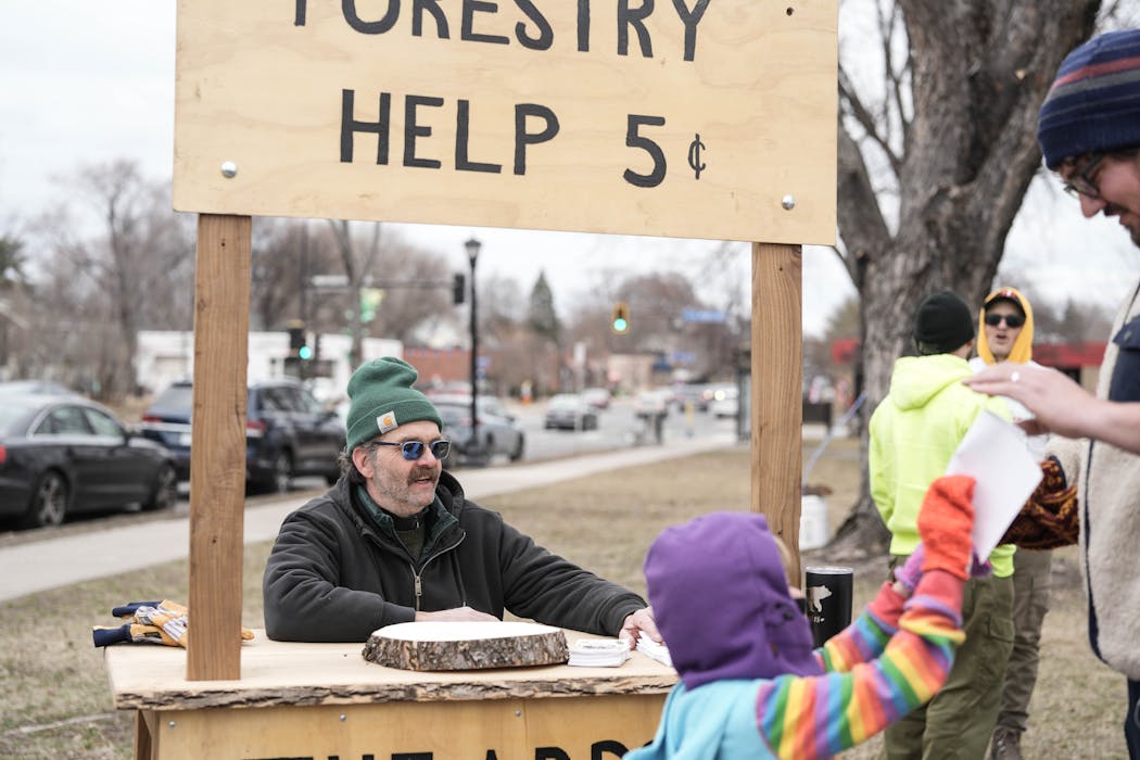 Park Board employee Dana Hendrickson answers forestry questions at a maple syruping event at Martin Luther King Jr. Park. Hendrickson and his brother Jason are part of an arborist family that has taken care of Minneapolis parks for generations.
