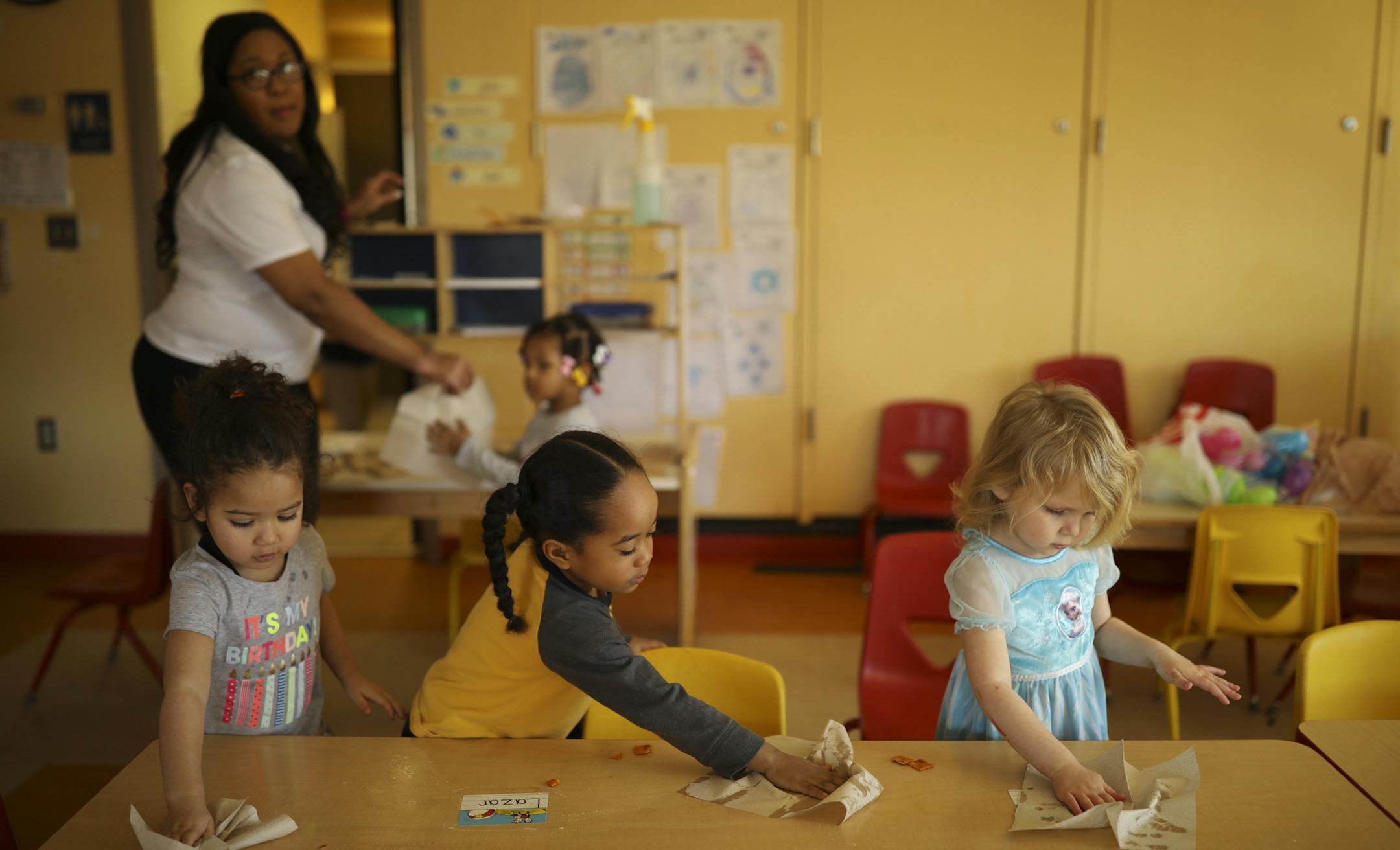 Lyah, B.J., and Bravery, from left, cleaned up their table after an afternoon snack in Deedra Porter's preschool room Thursday afternoon. ] JEFF WHEELER ï jeff.wheeler@startribune.com The Mary T. Wellcome Child Development Center at Phyllis Wheatley Community Center in Minneapolis receives some of its funding from the Greater Twin Cities United Way at a time when the charity has seen a $25 million drop in revenue in the last three years. Children in Deedra Porter's preschool classroom had t