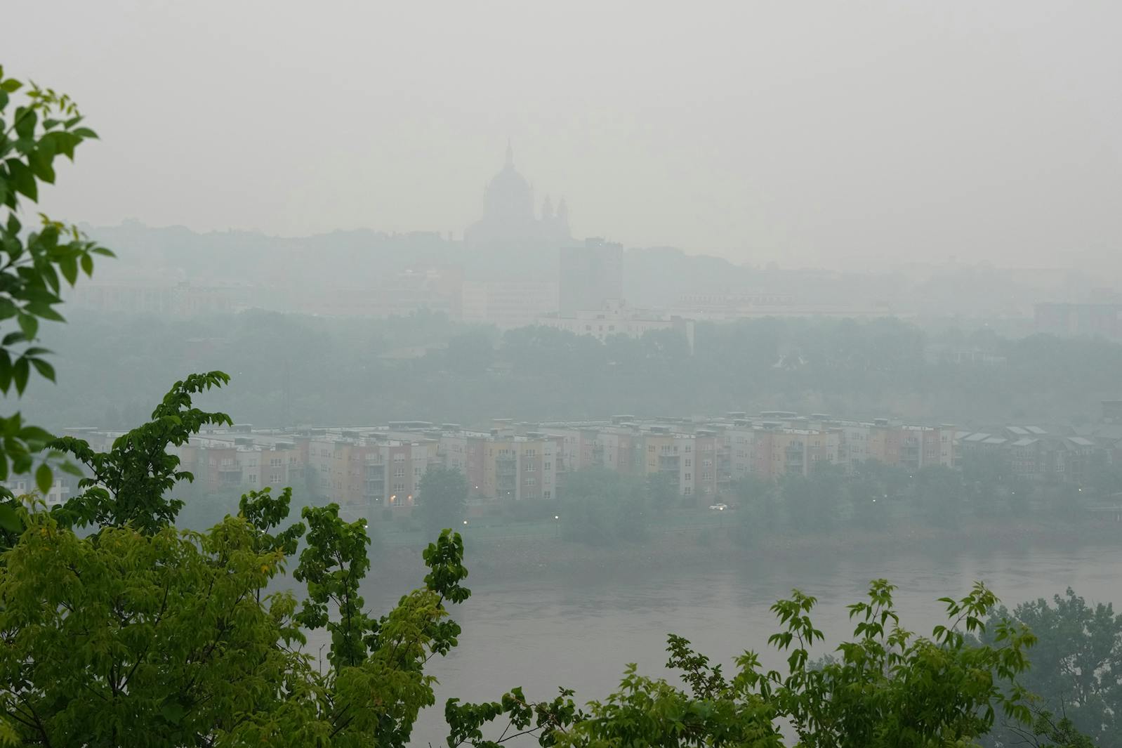The Cathedral of St. Paul is seen through wildfire smoke and rainy conditions from across the Mississippi River in St. Paul on Tuesday morning. A statewide air-quality alert caused by wildfire smoke has been stretched to Wednesday by the Minnesota Pollution Control Agency.