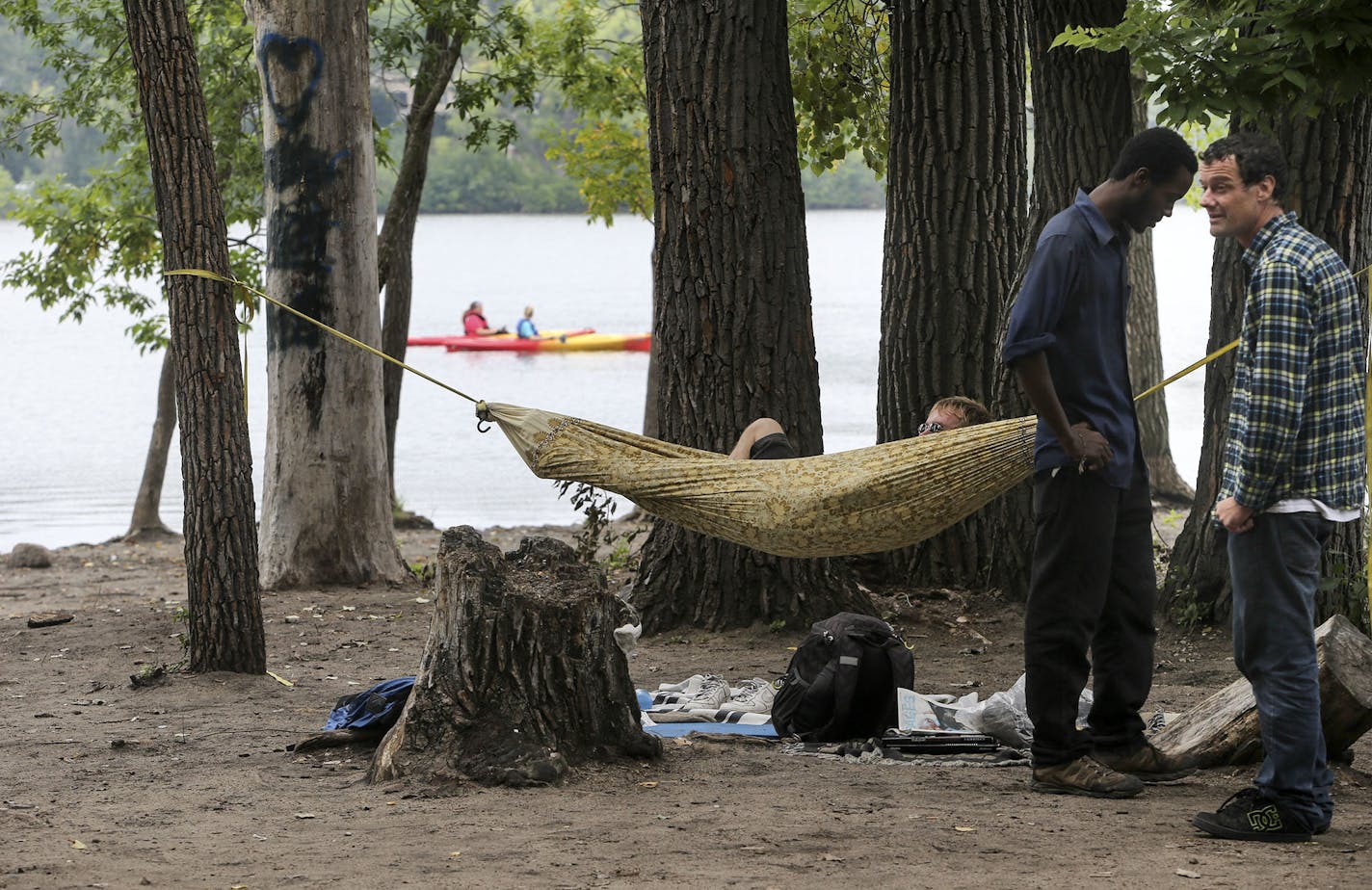 Shane Hathaway grew up in Minneapolis and has been coming to Hidden Beach in the Kenwood Isle neighborhod for 18 years. Hathaway says it is an accepting environment, where talented, passionate people get together to hang out, chat and even "network" for business. He was seen with Cory MacSleynel, in the hammock, and a man wishing to be unidentified and seen Saturday, Aug. 23, 2014, in Minneapolis, MN. ] (DAVID JOLES/STARTRIBUNE) djoles@startribune The Kenwood Isle neighborhood may ask the Park B