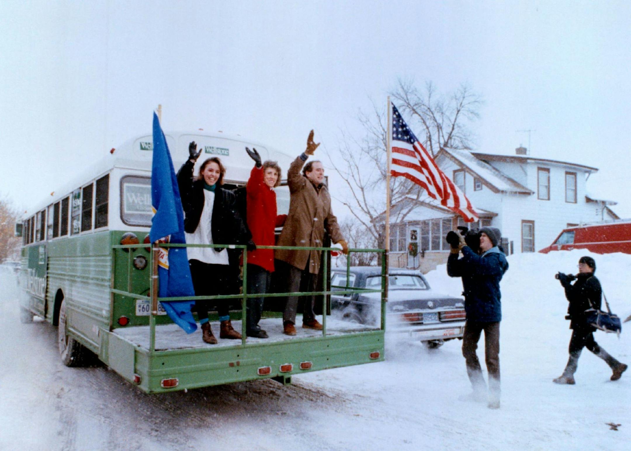 December 30, 1990 Washington or bust Sen.-elect Paul Wellstone, group with his daughter Marcia and wife, Shella, waved farewell from his bus Saturday before heading for Washington, D. C. The bus was used by Wellsotne in his campaign, and despite its rattletrap nature and yesterday's cold weather, it did well on the first leg of the trip. Joey McLeister, Minneapolis Star Tribune