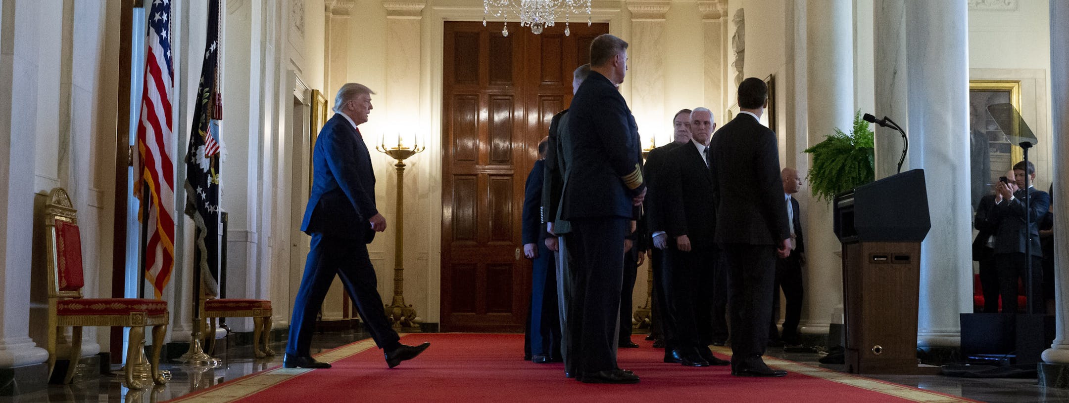 President Donald Trump, left, arrives to address the nation on the ballistic missile strike that Iran launched against Iraqi air bases housing U.S. troops, at the White House, Wednesday, Jan. 8, 2020, in Washington. (AP Photo/Alex Brandon)