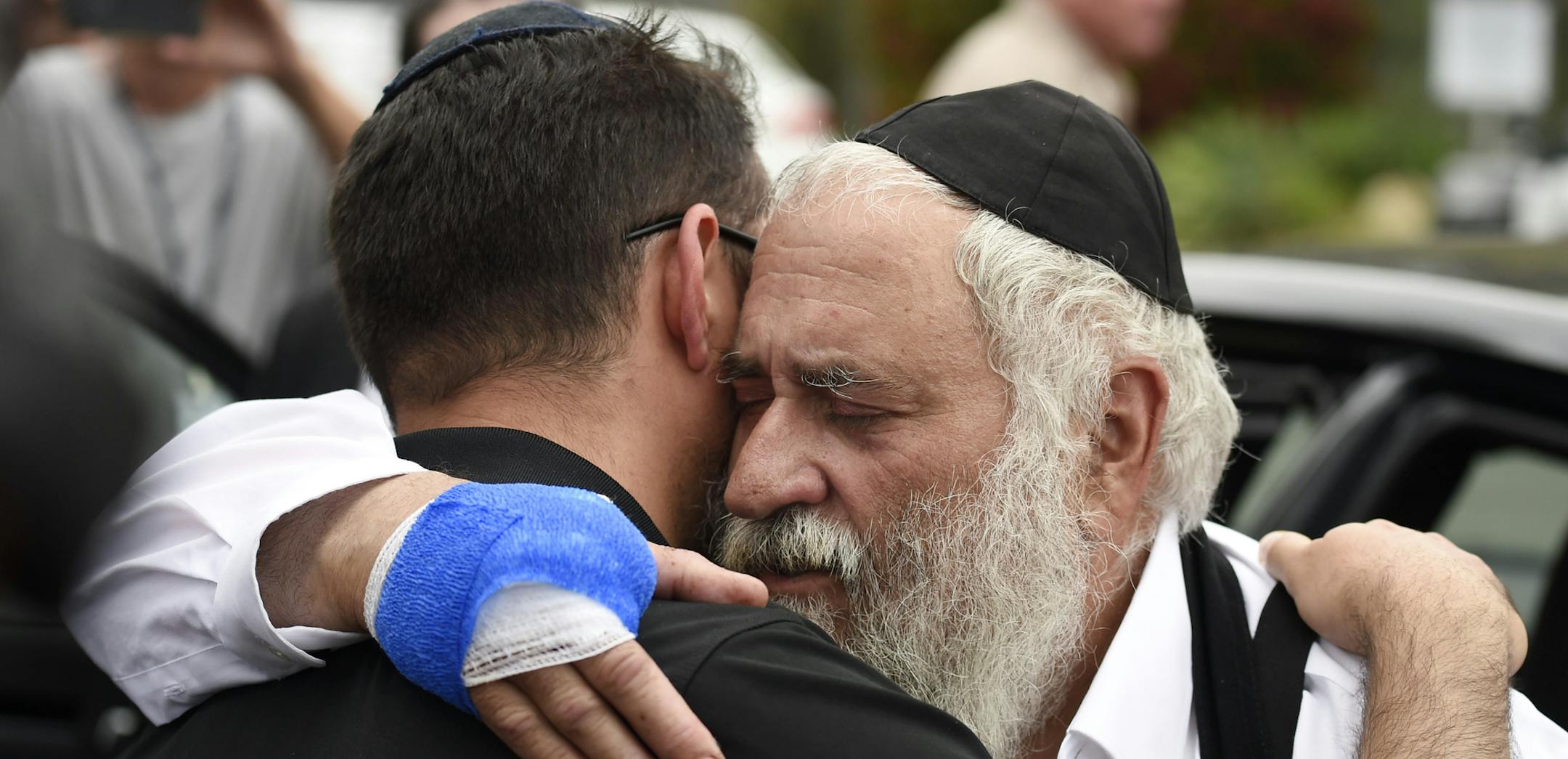 Rabbi Yisroel Goldstein, right, is hugged as he leaves a news conference at the Chabad of Poway synagogue, Sunday, April 28, 2019, in Poway, Calif. A man opened fire Saturday inside the synagogue near San Diego as worshippers celebrated the last day of a major Jewish holiday. (AP Photo/Denis Poroy)