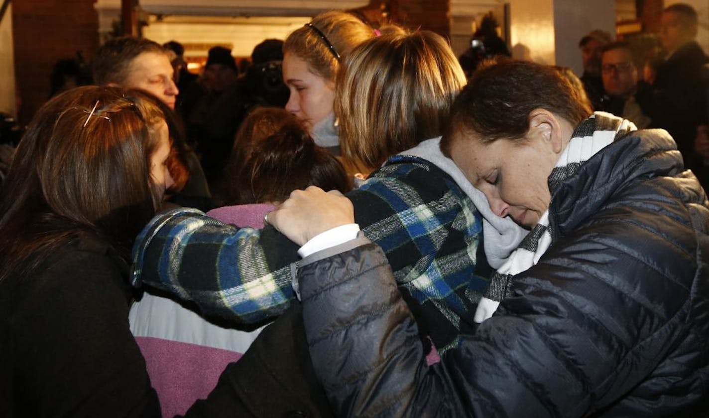 Girls embraces outside St. Rose of Lima Roman Catholic Church, which was filled to capacity, during a healing service held in for victims of an elementary school shooting in Newtown, Conn., Friday, Dec. 14, 2012.