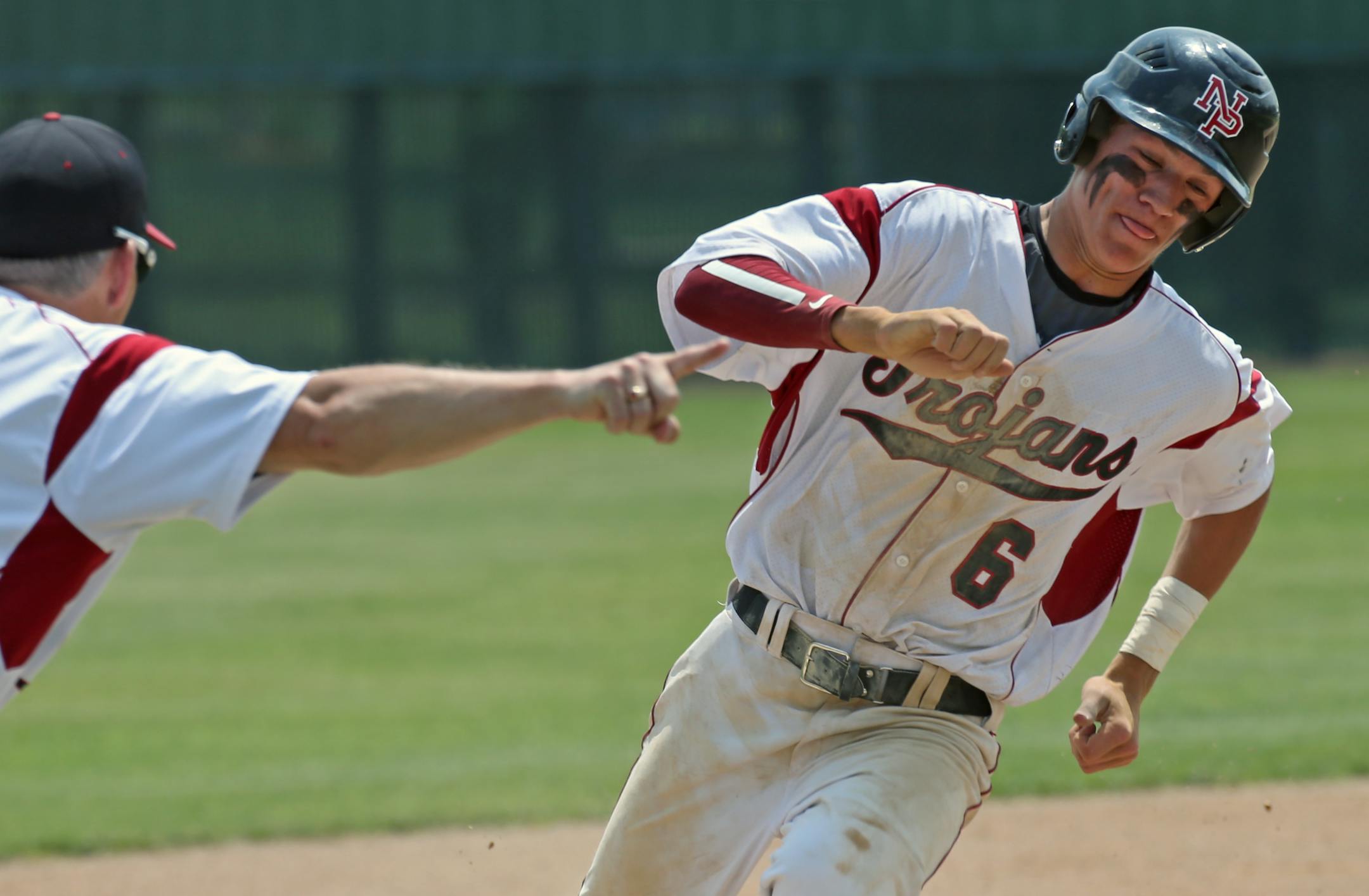 New Prague's Auggie Isaacson rounded third base. (Bruce Bisping/Star Tribune)