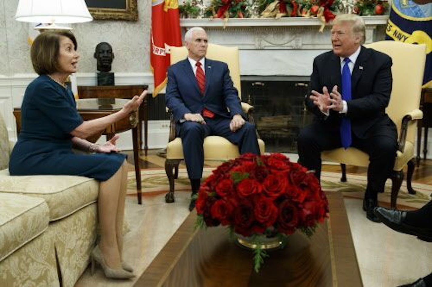 Vice President Mike Pence, center, looks on as House Minority Leader Rep. Nancy Pelosi, D-Calif., and President Donald Trump speak during a meeting in the Oval Office of the White House, Tuesday, Dec. 11, 2018, in Washington. Democratic Sen. Chuck Schumer was also present.